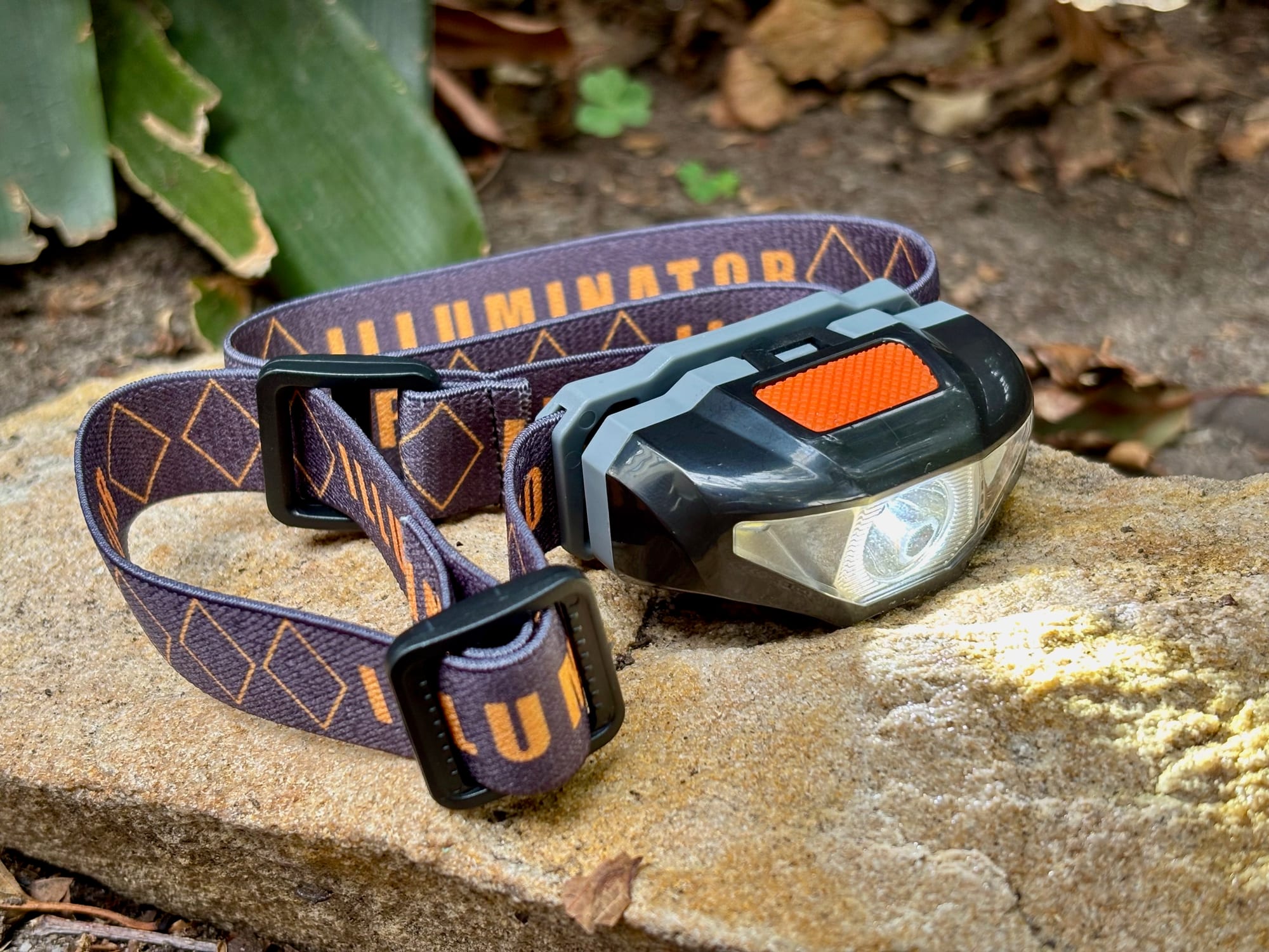 Adventure Kings Illuminator LED head torch on a sandstone rock