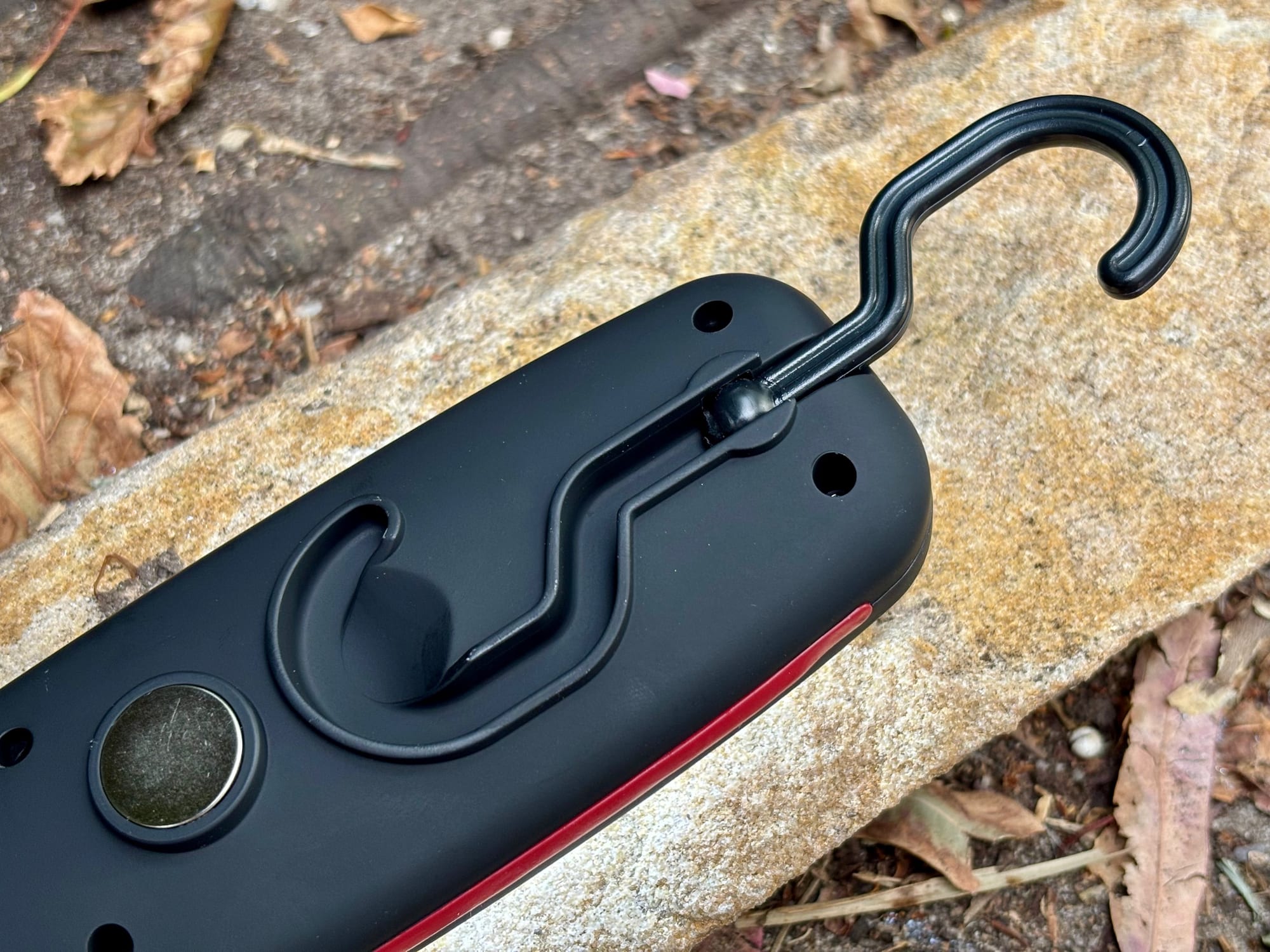 The back of the Adventure Kings Illuminator LED work light with its hook and magnet