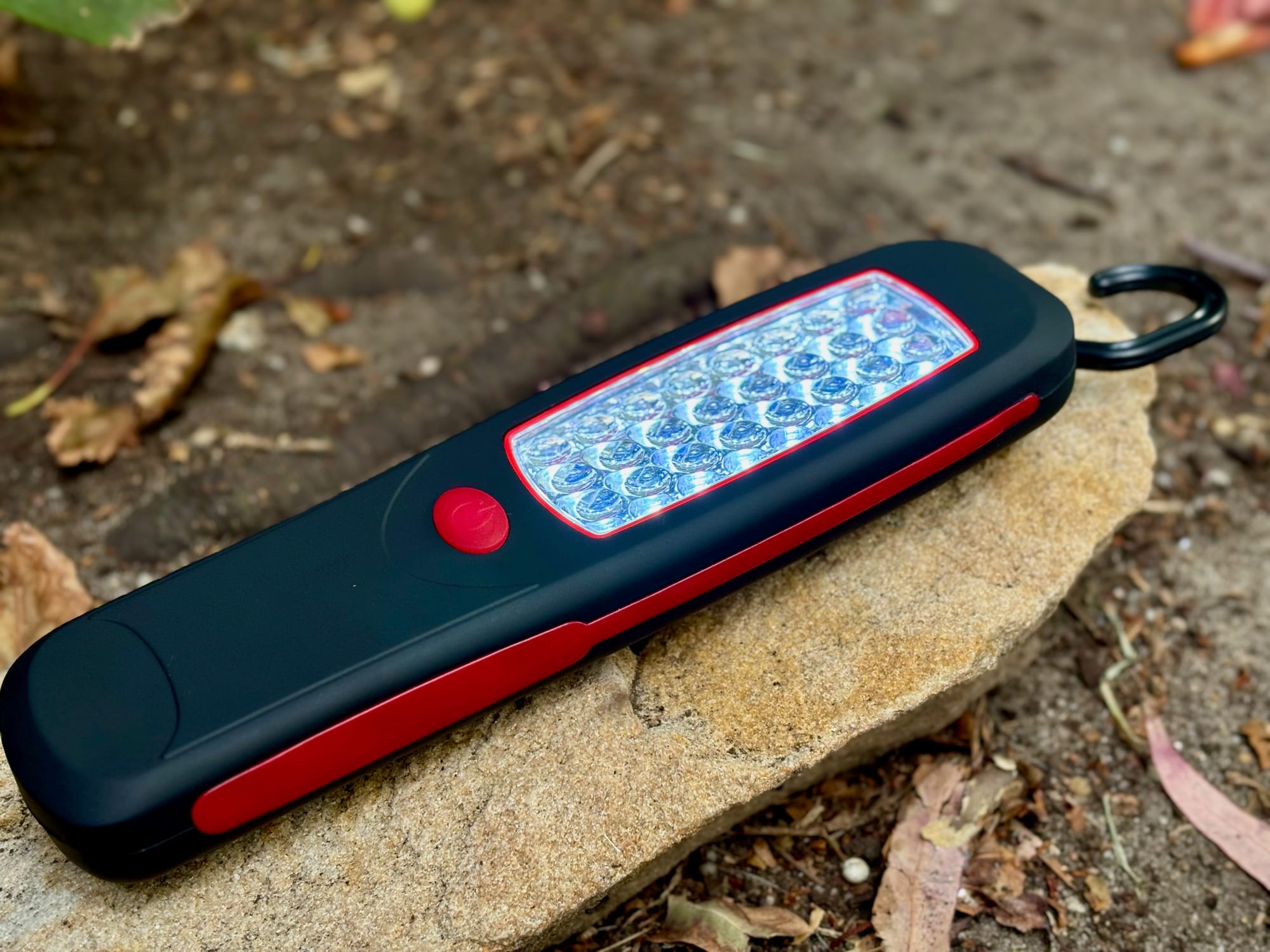 The Adventure Kings Illuminator LED work light lying on a sandstone rock