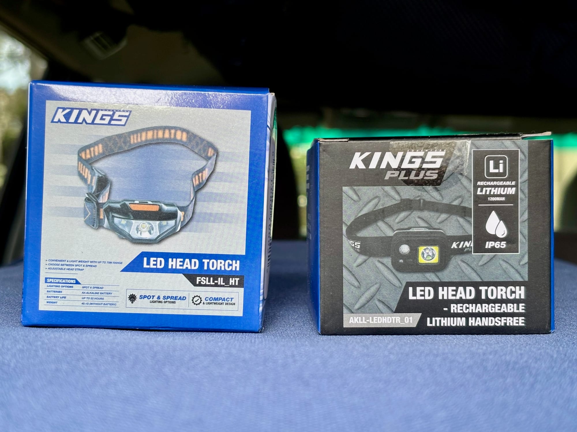 The Adventure Kings lithium LED head torch box next to the box of the Kings Illuminator head torch