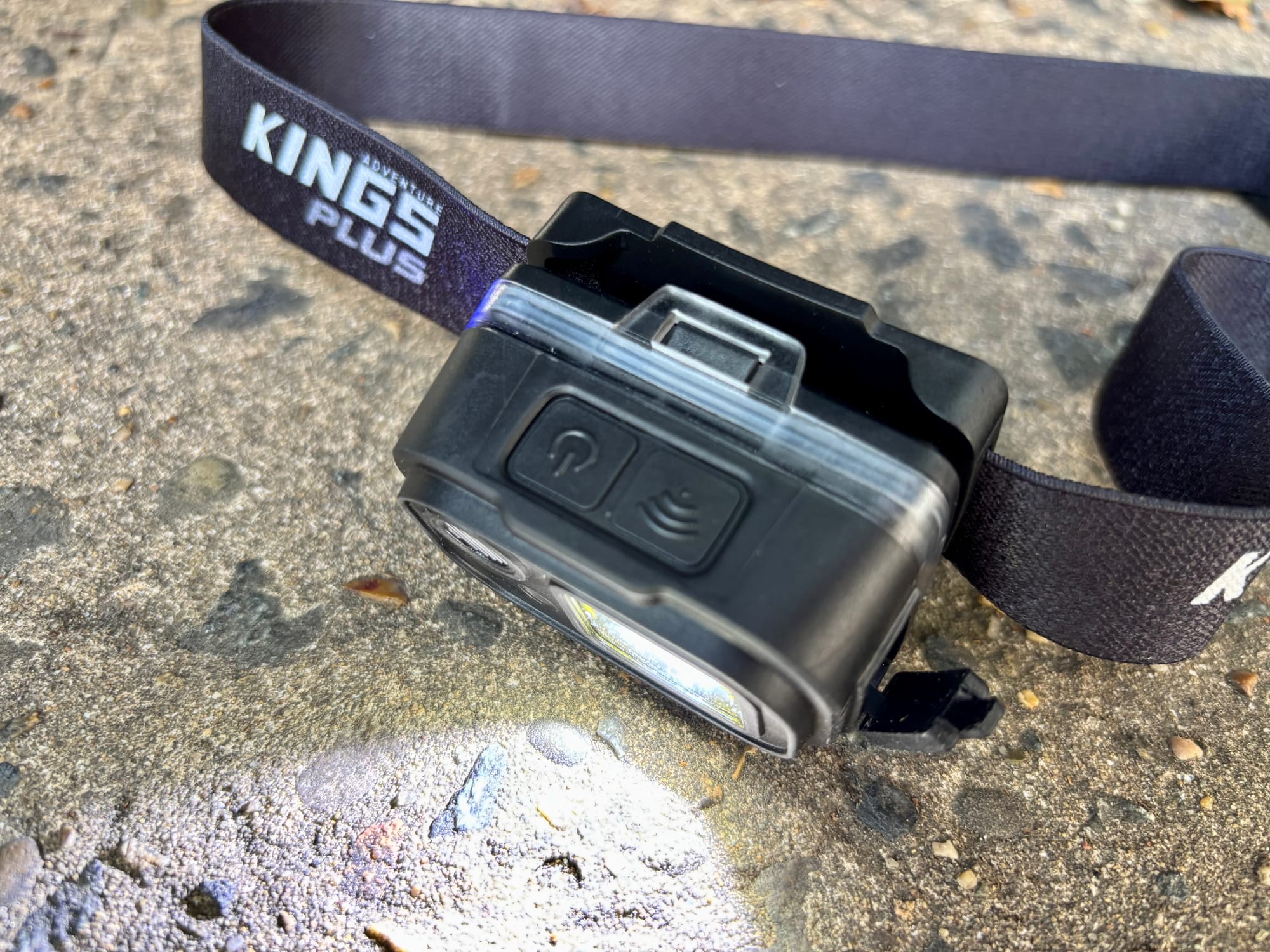 The two buttons on top of the Adventure Kings head torch, with the light on
