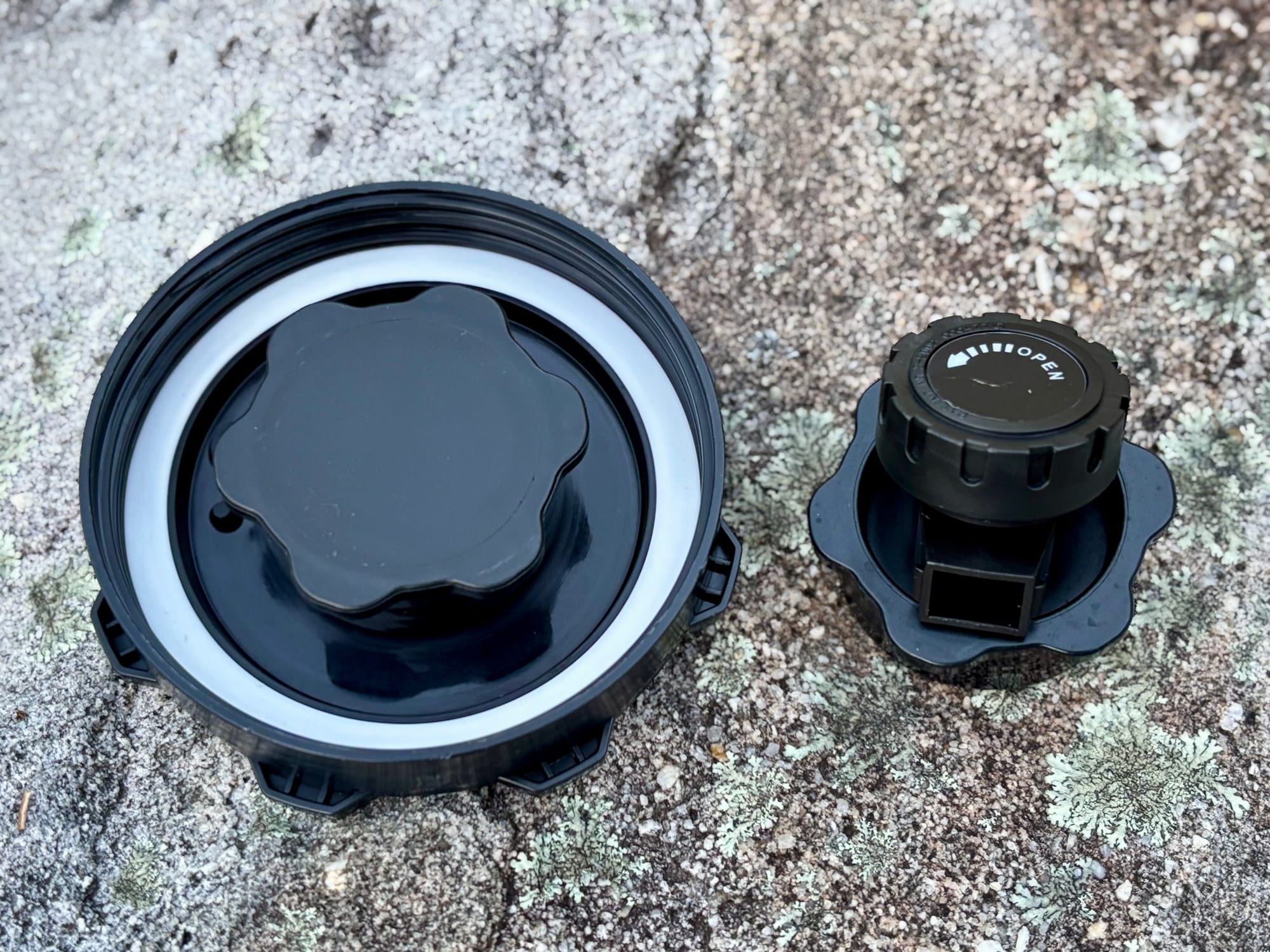 The underside of the big lid with the spare cap screwed into it, next to the tap