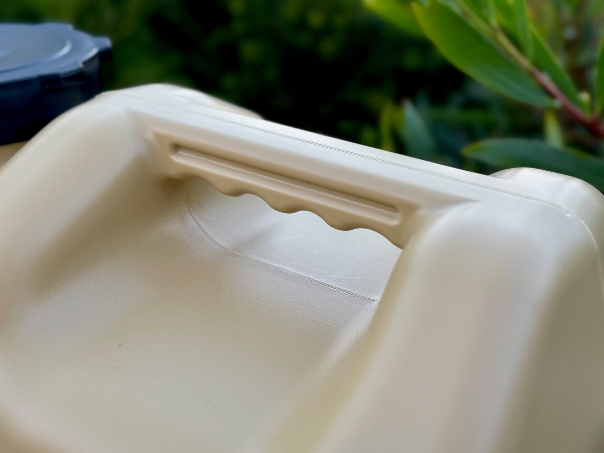 Close-up of the carry handle with finger grooves along its underside