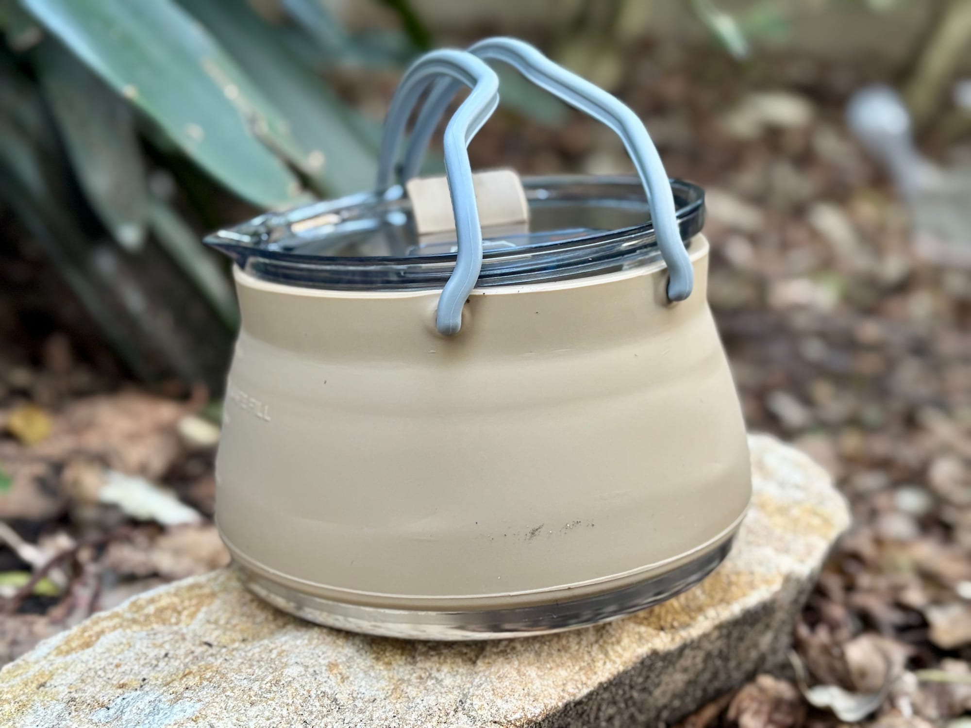 The Aimall collapsible kettle expanded to full size on a rock