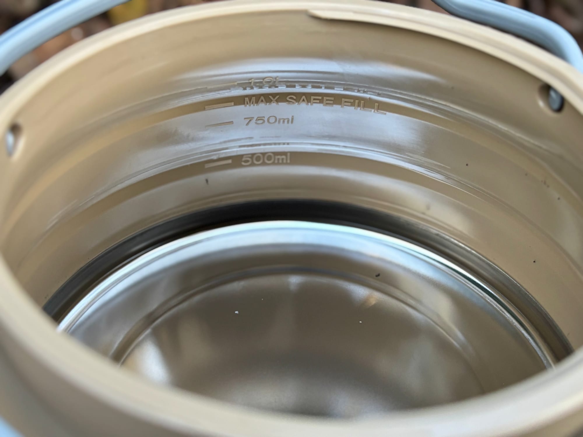 The 500 ml, 750 ml and 1 litre lines inside the Aimall kettle above the steel base