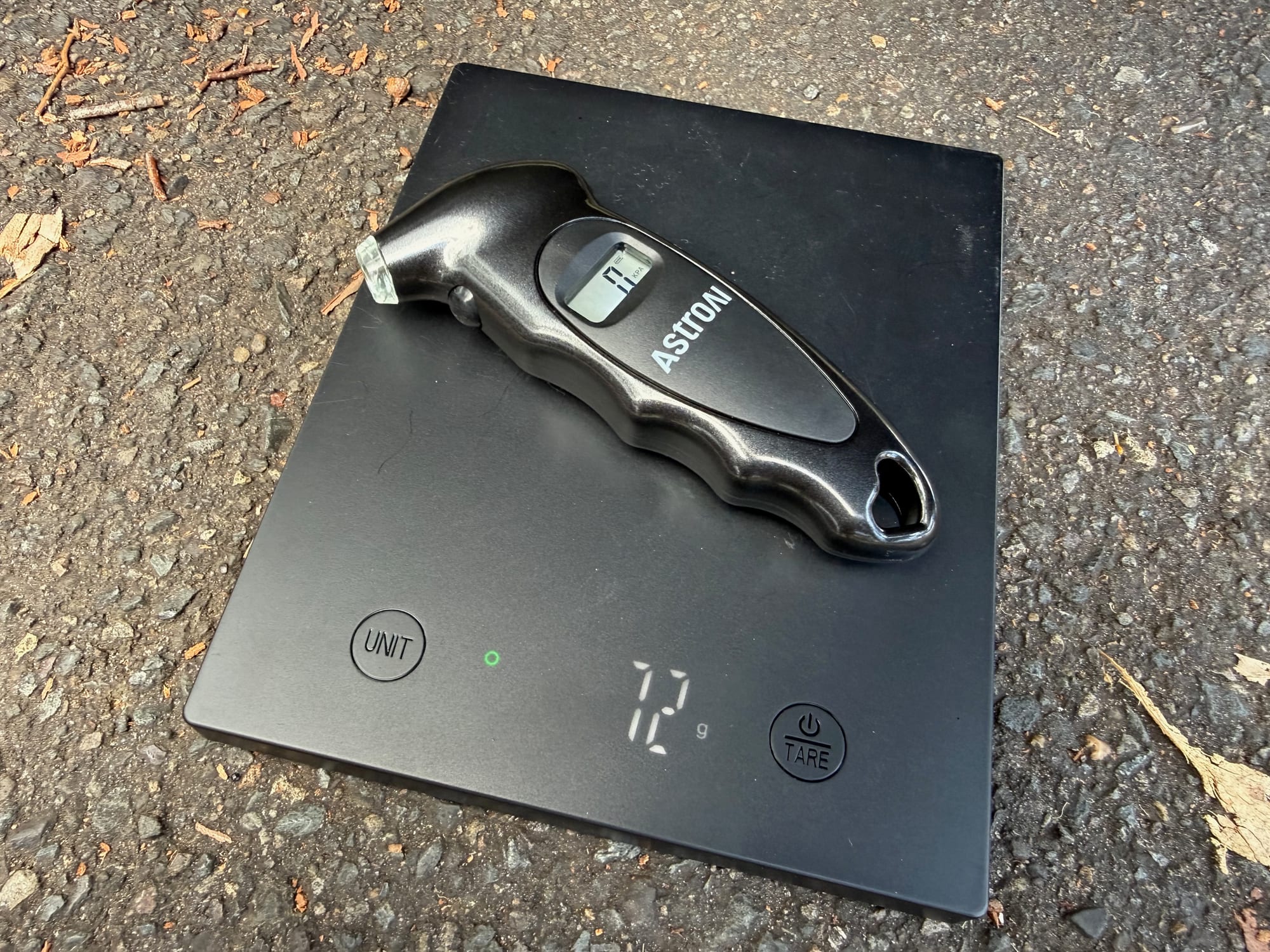 The AstroAI digital tyre pressure gauge on the scale at 72 g