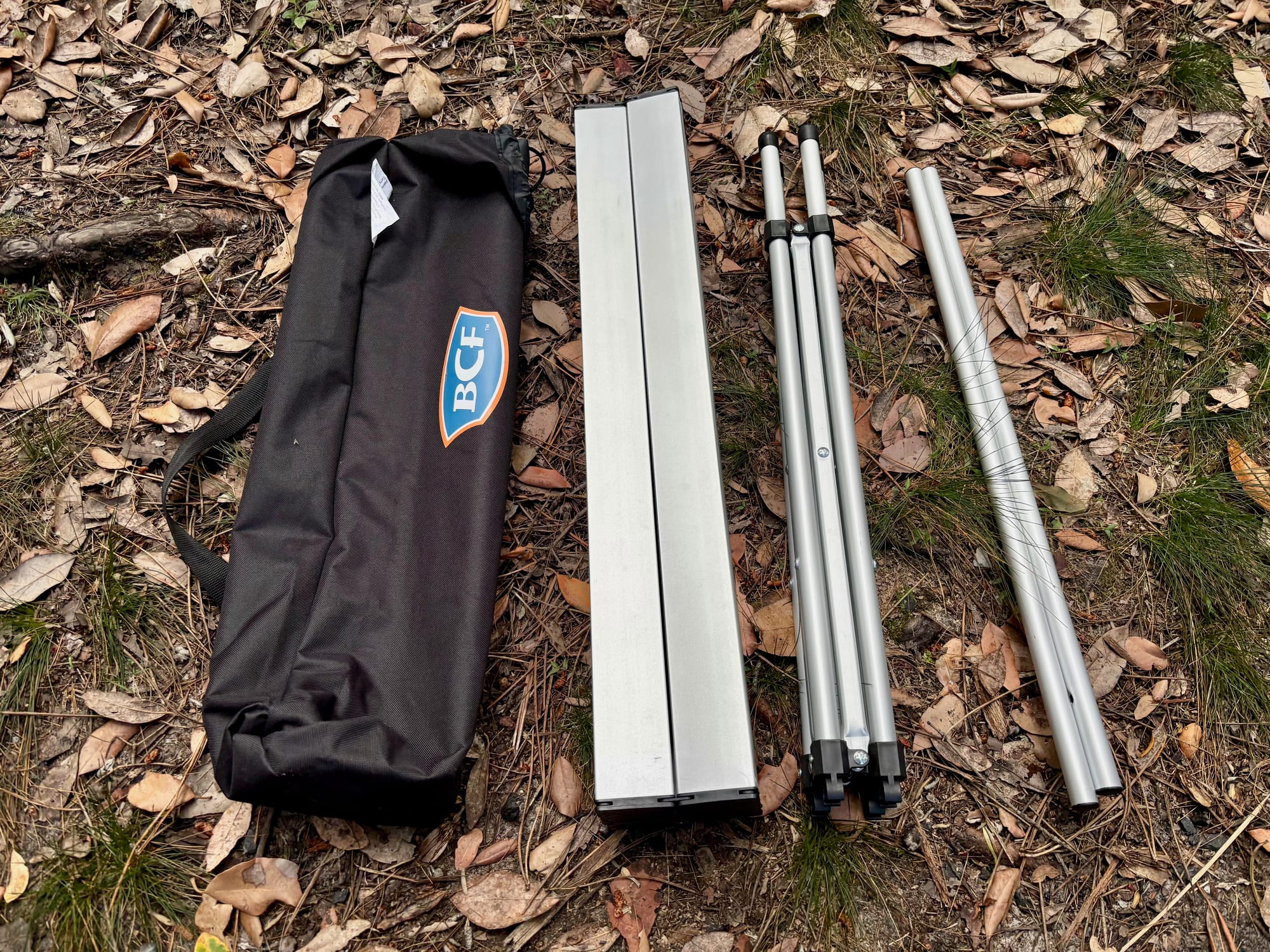 The parts of the BCF roll up table laid out: bag, rolled top, folded frame and cross bars