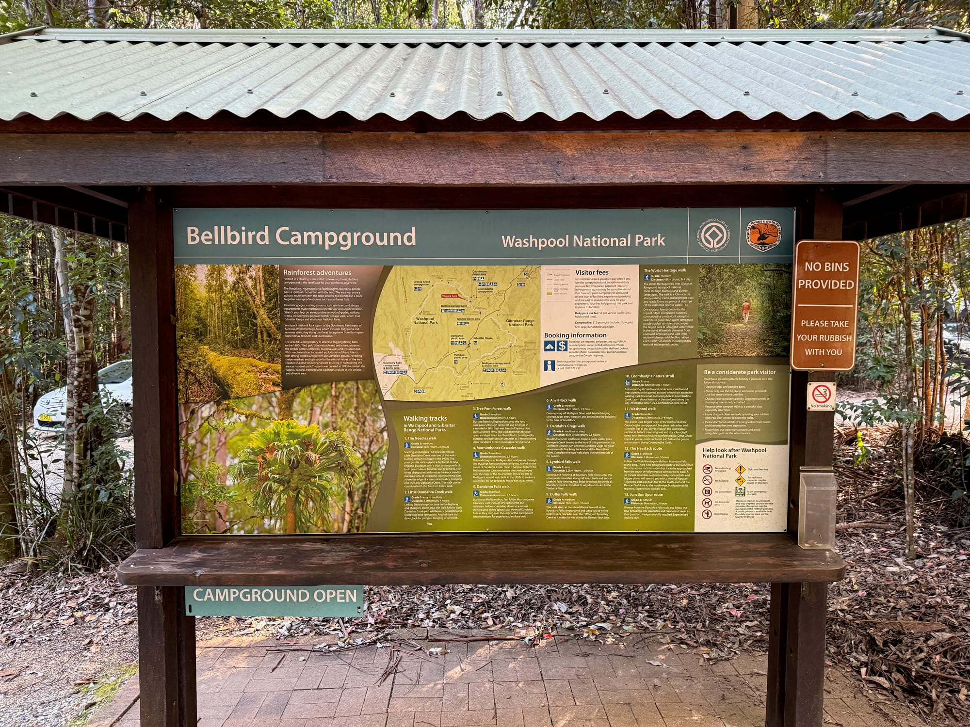 The Bellbird Campground information board with a map of Washpool National Park and a No bins provided sign