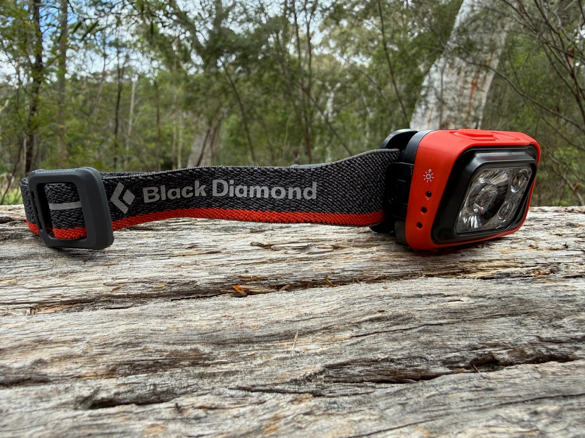 The Spot 400 with its white light on, on a log