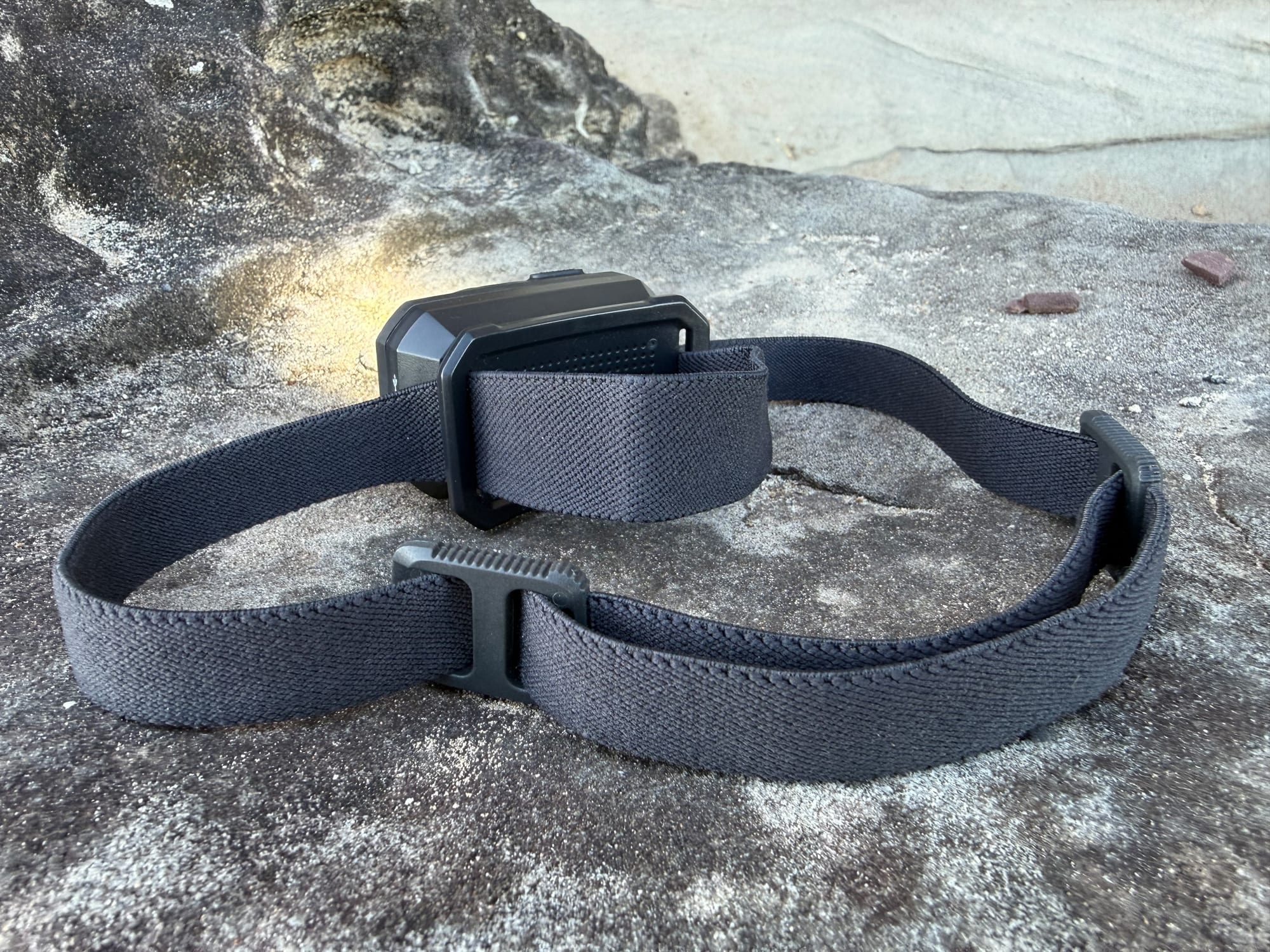 The Storm 500-R with its wide grey headband laid out on a sandstone rock