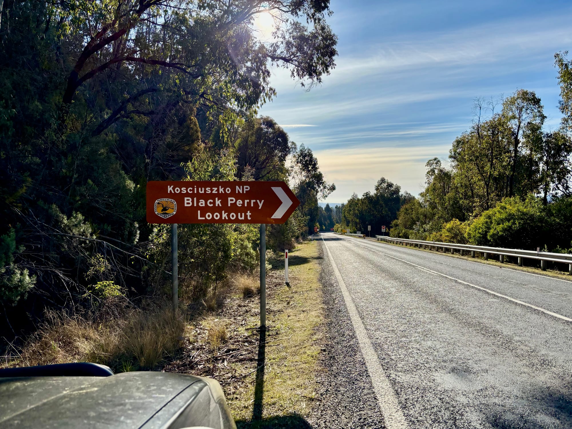 The brown road sign for Black Perry Lookout on the Snowy Mountains Highway