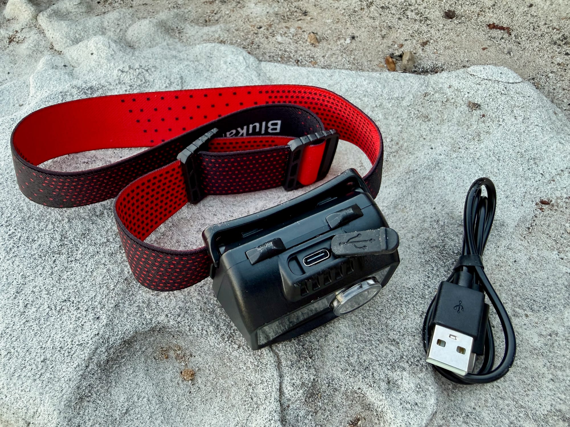 The USB-C charging port and cable of the Blukar K9111 headlamp