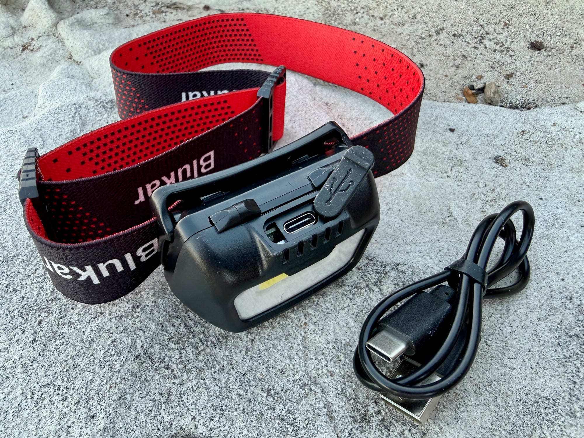 The USB-C charging port and cable of the Blukar K9112 headlamp