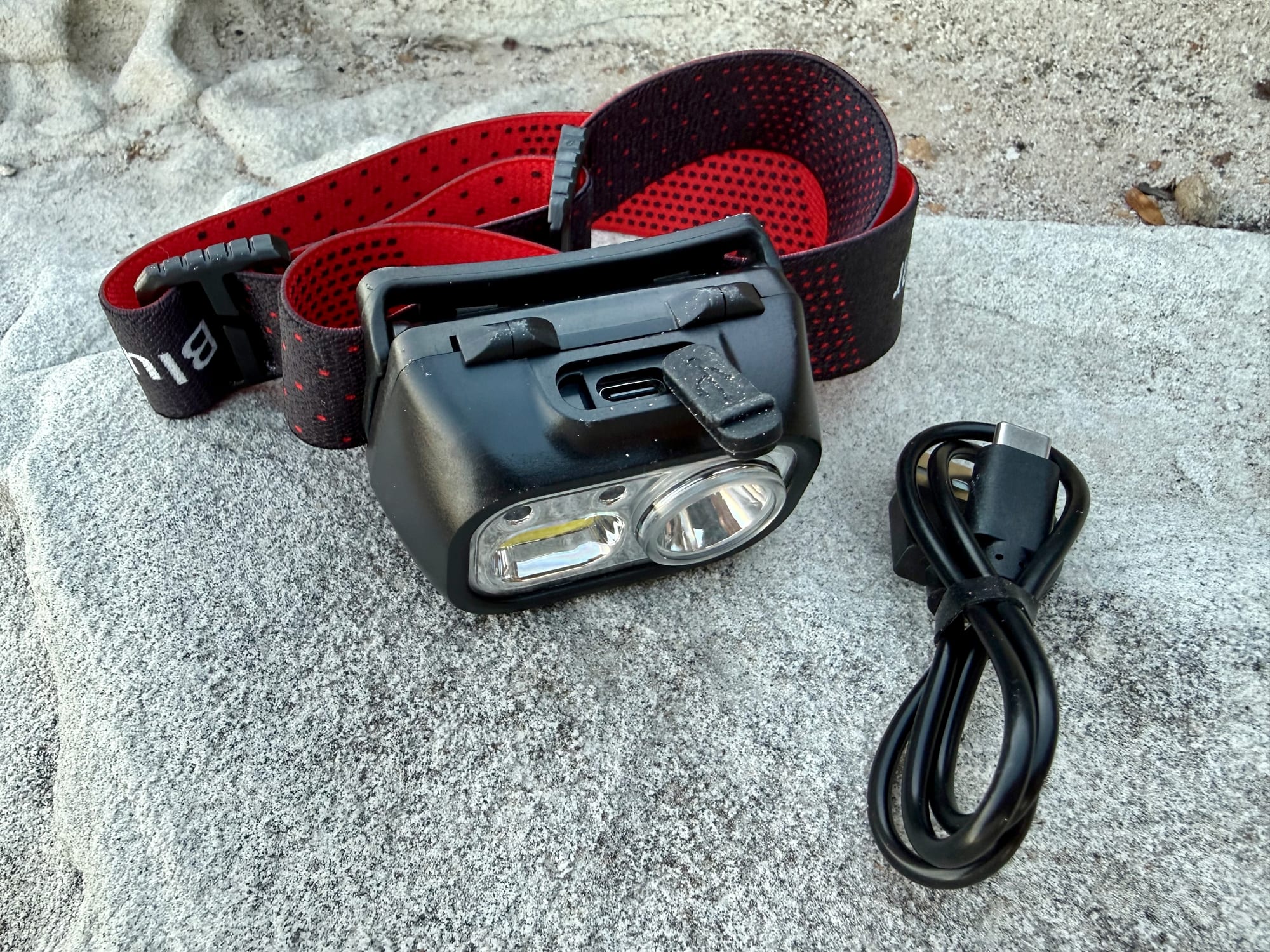 The USB-C charging port and cable of the Blukar K9125 headlamp