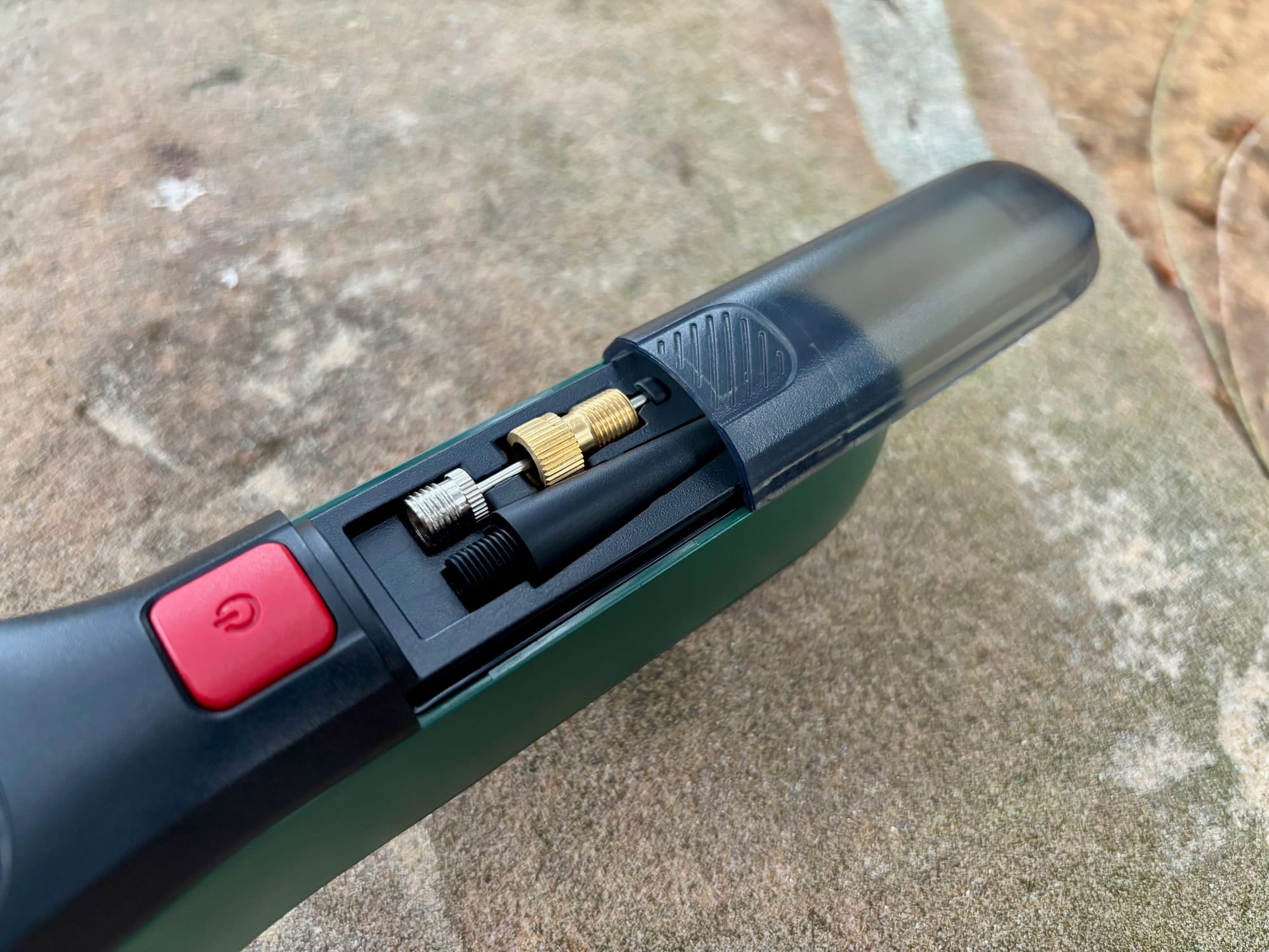 The valve adapters stored under the clear cover in the handle of the Bosch EasyPump