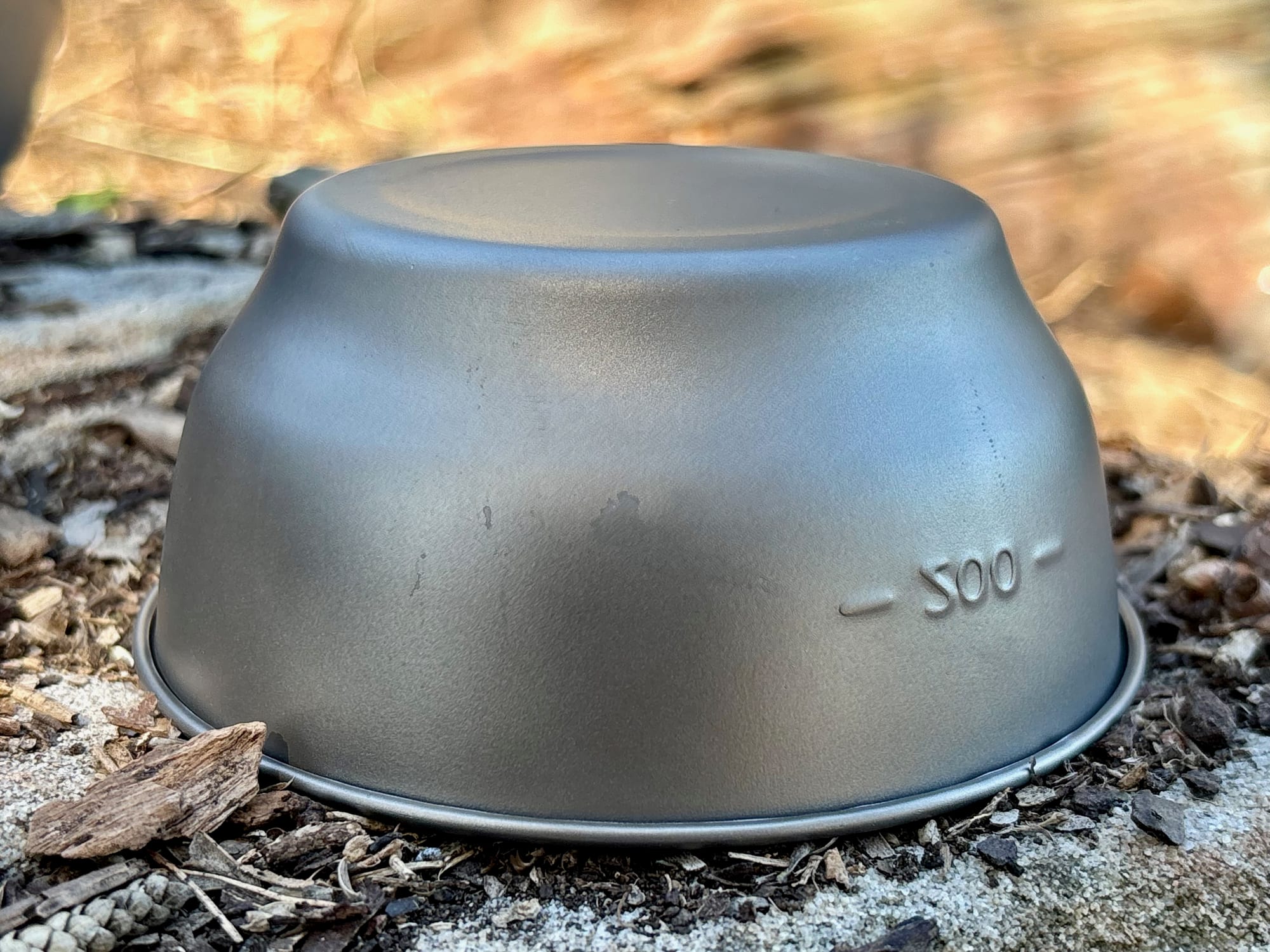 The titanium bowl upside down on a rock