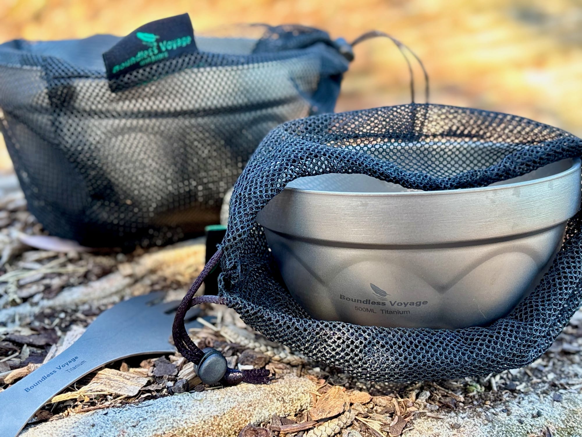 The titanium bowl going into its black mesh drawstring bag