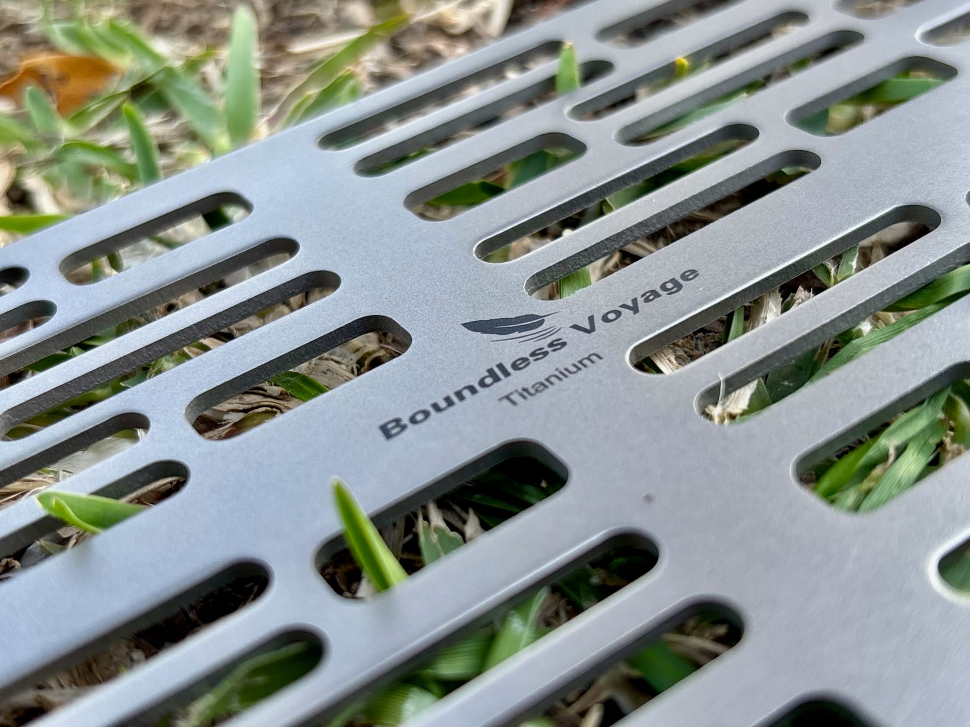 Close-up of the Boundless Voyage Titanium logo between the slots of the Ti2023C grill plate