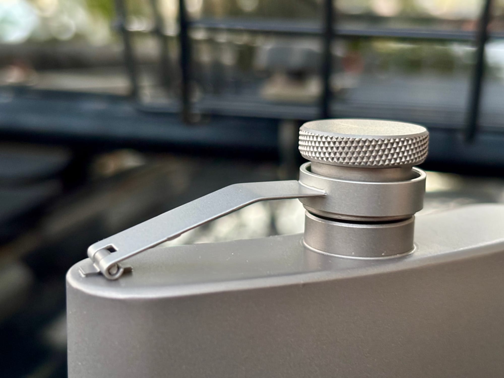 Close-up of the knurled screw cap on its titanium arm, on top of the flask