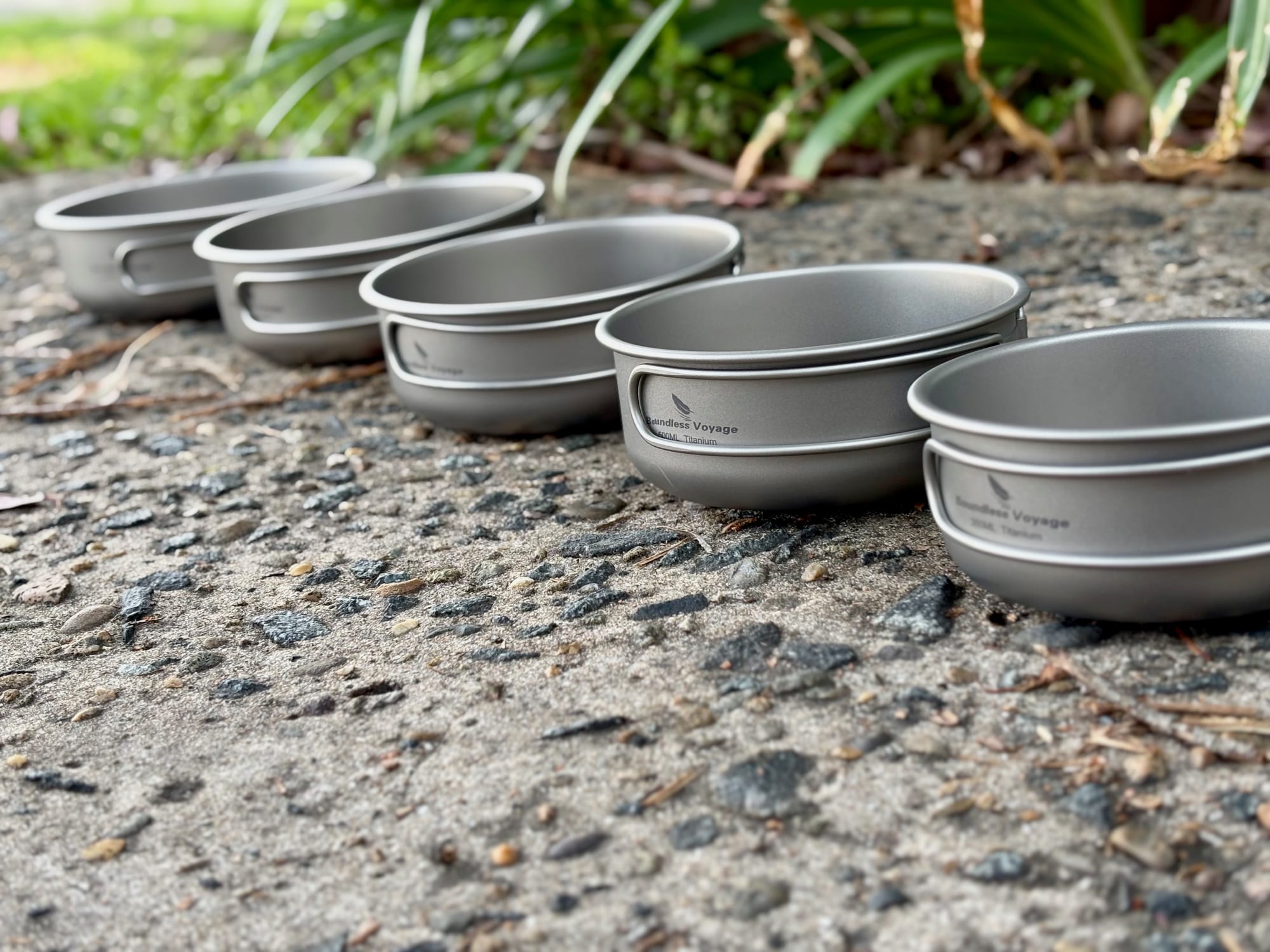 The five Boundless Voyage titanium pans lined up in a row from large to small