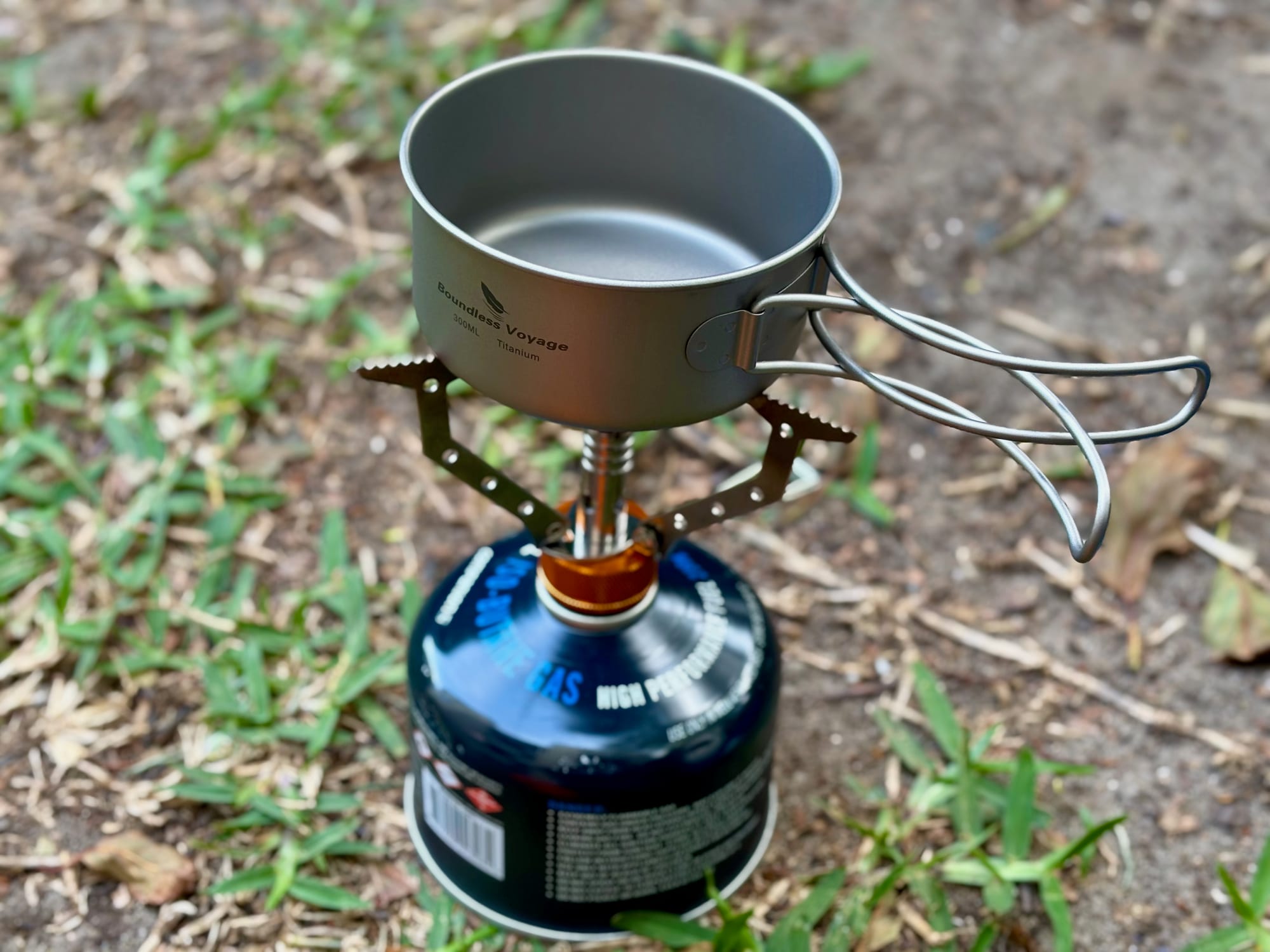 The 300 ml titanium pan heating on a gas canister stove