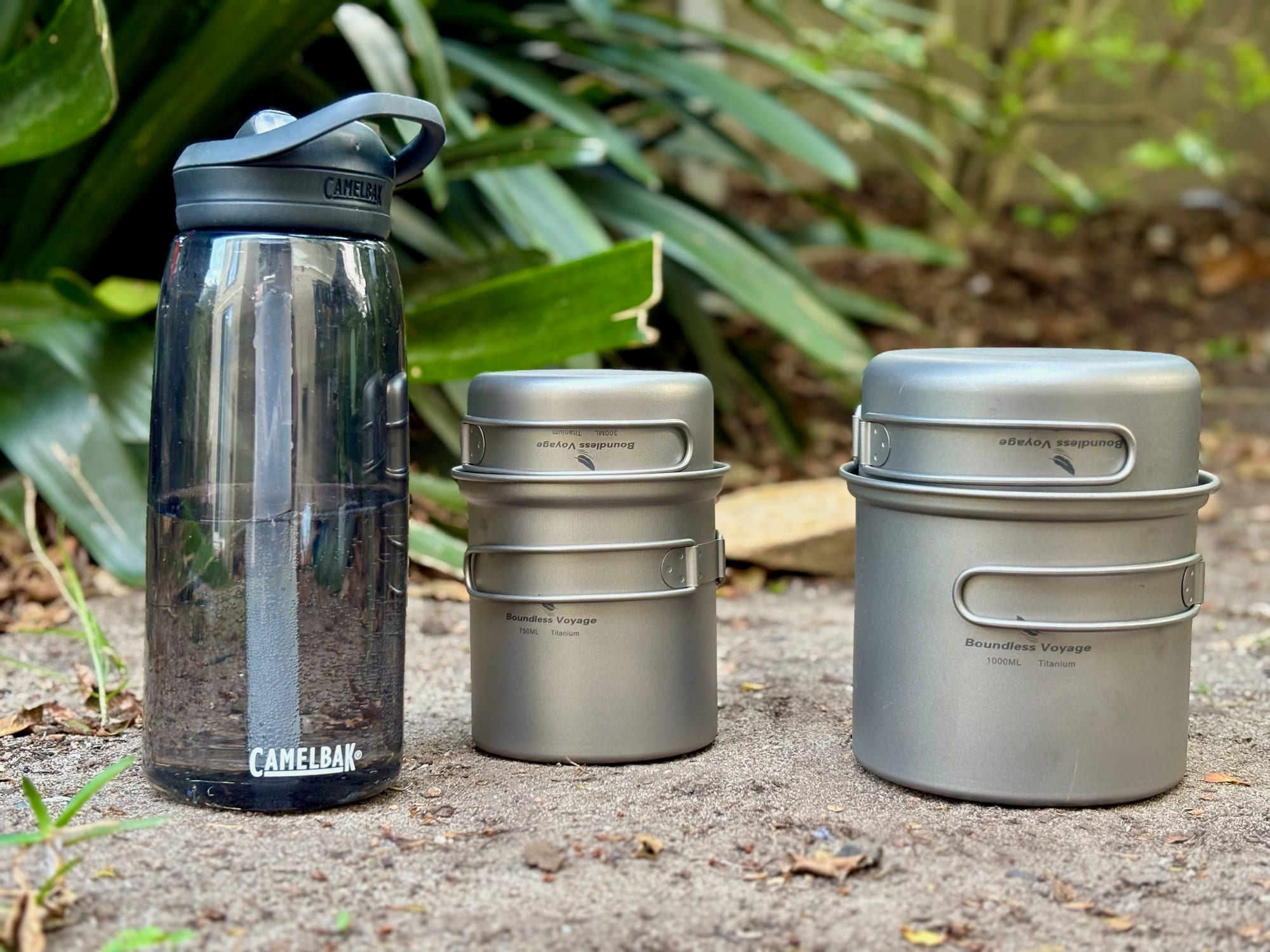 The 750 + 300 ml set and the bigger 1000 + 500 ml set next to a 1 litre CamelBak water bottle