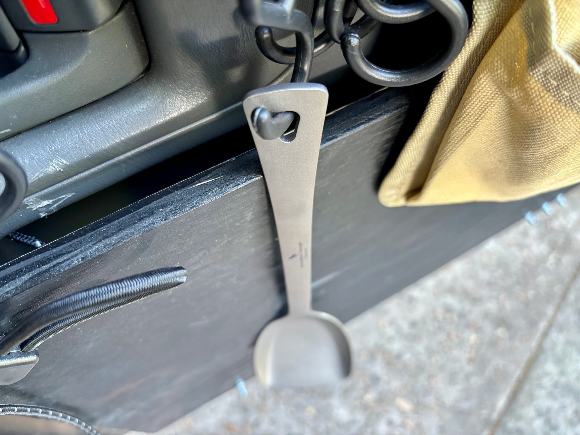 The Ti1073T spatula hanging by its heart-shaped hole from an S-hook