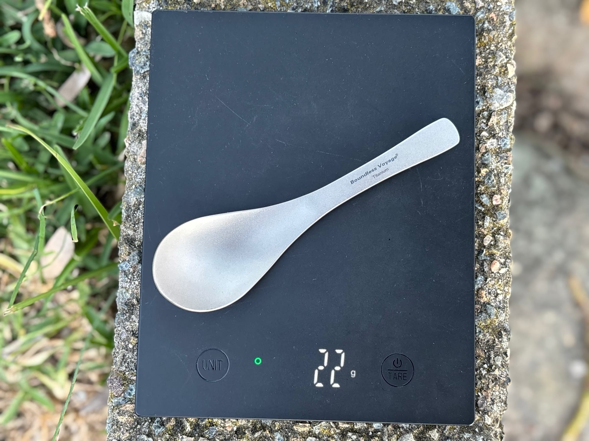 The titanium spoon on a digital scale showing 22 grams