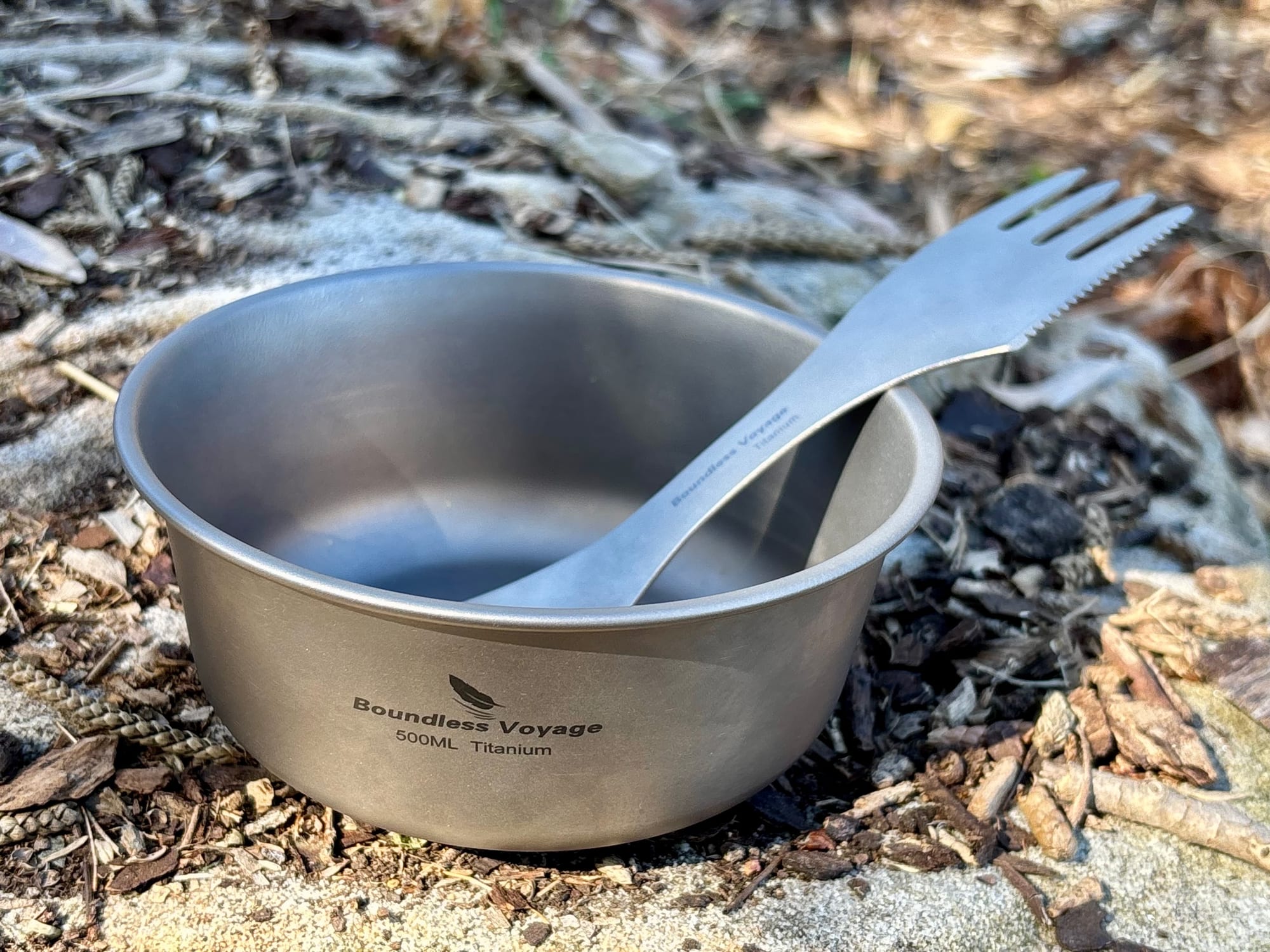 The titanium spork resting in a single-wall Boundless Voyage titanium bowl on a rock