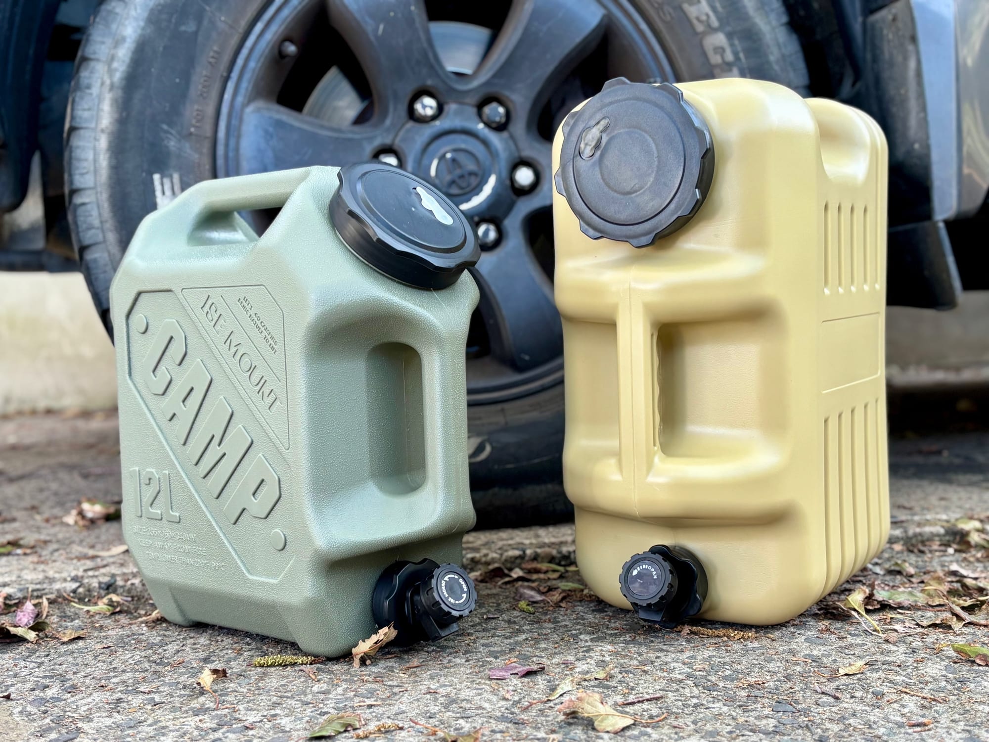 The green 12 L container next to the beige Aimall 18.5 L, in front of a 4WD wheel