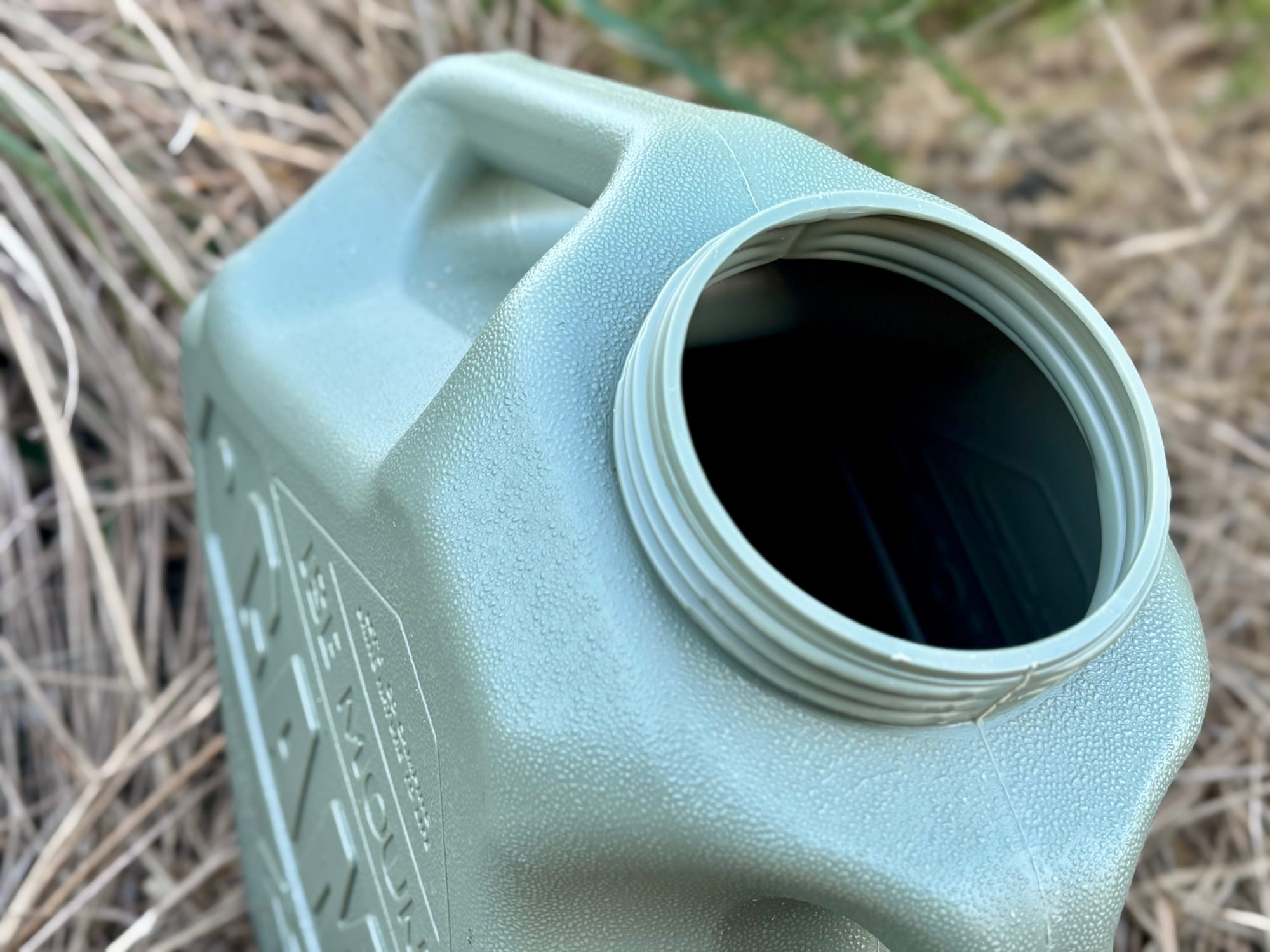 The wide mouth of the container with the lid off