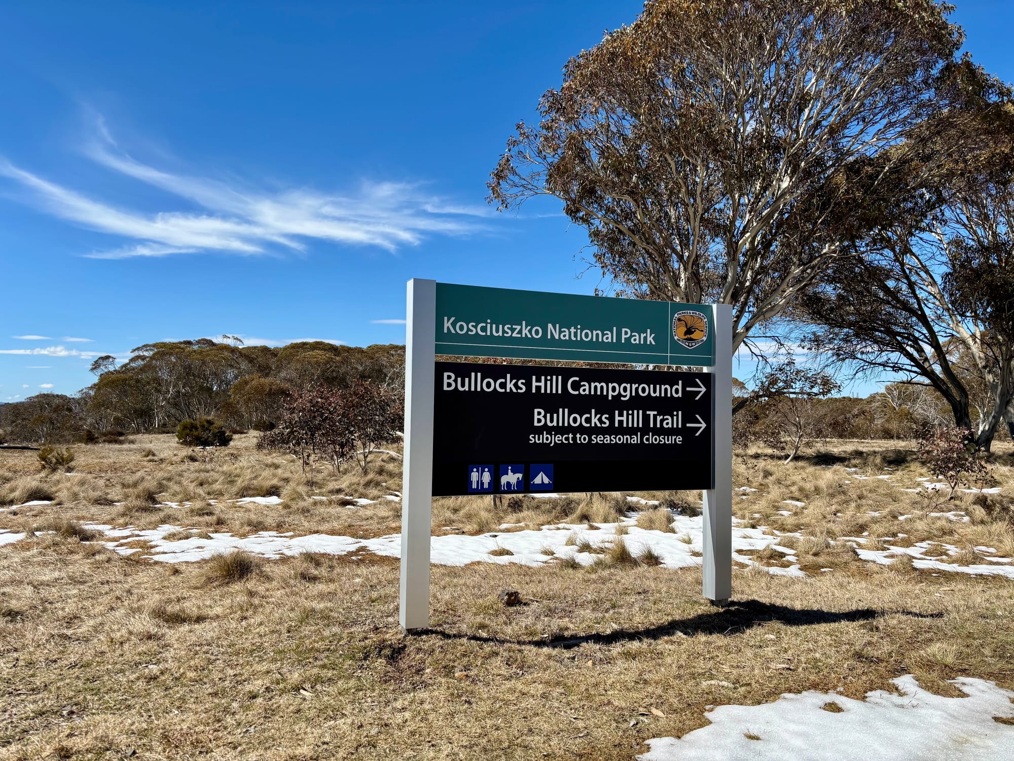 The Kosciuszko National Park sign at the turn-off to Bullocks Hill Campground and Bullocks Hill Trail