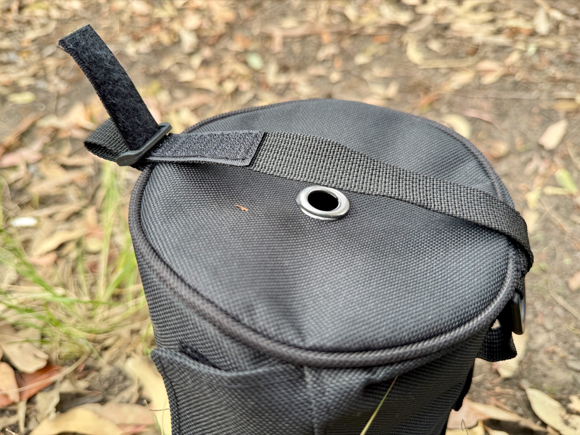 The lid of the toilet roll holder with its metal grommet in the centre