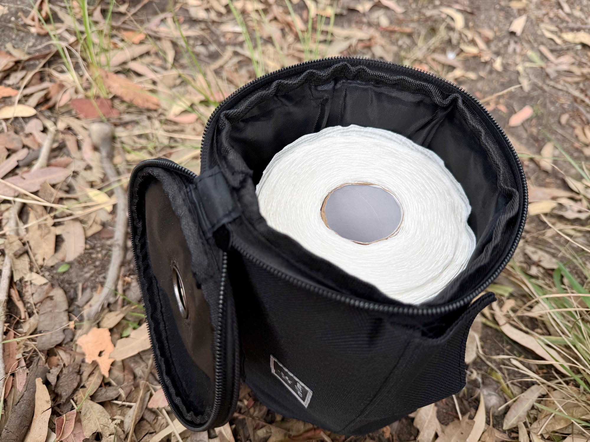 The toilet roll holder unzipped with a full toilet roll inside