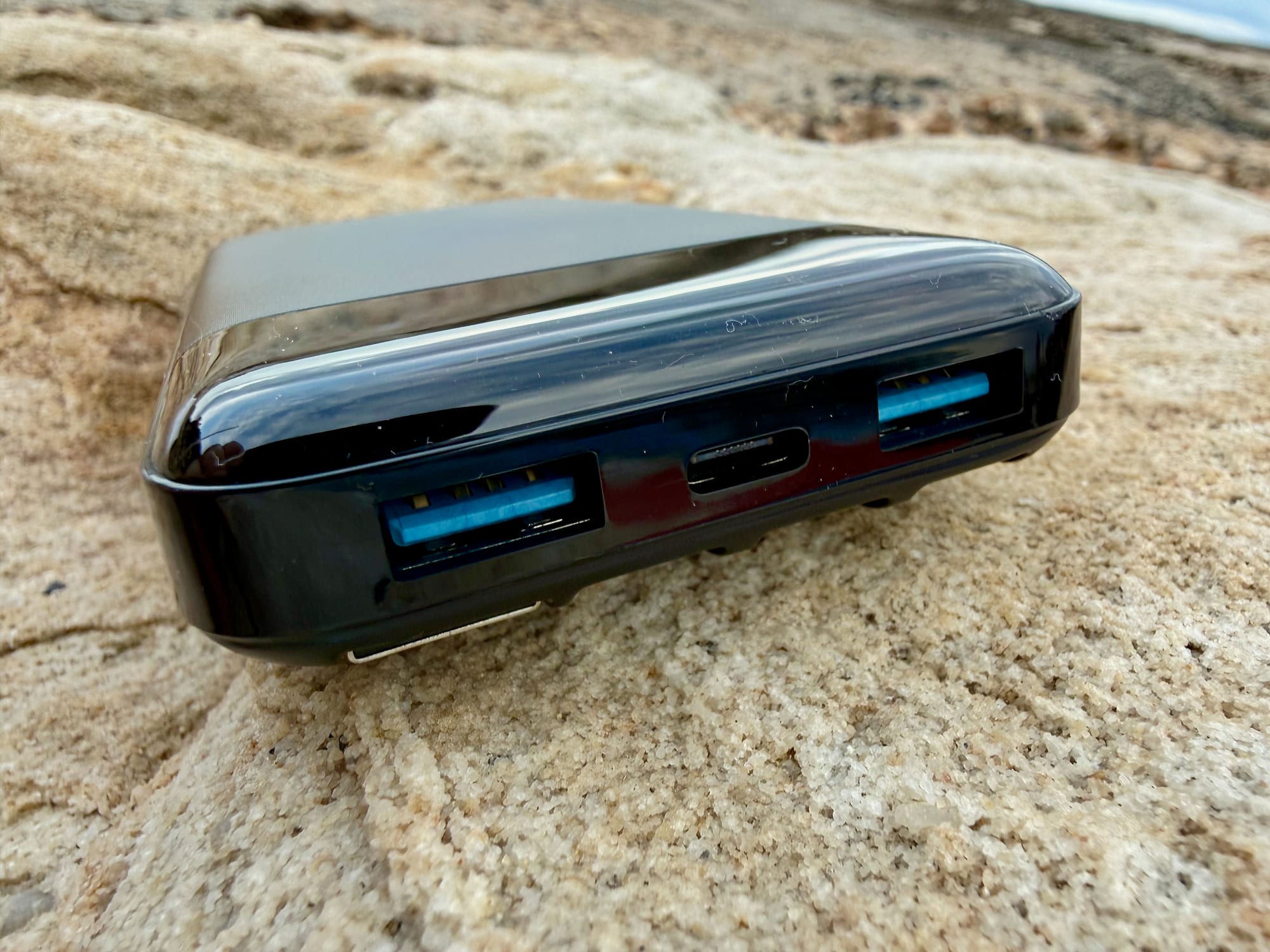 The two USB-A ports and the USB-C port on the end of the Charmast power bank
