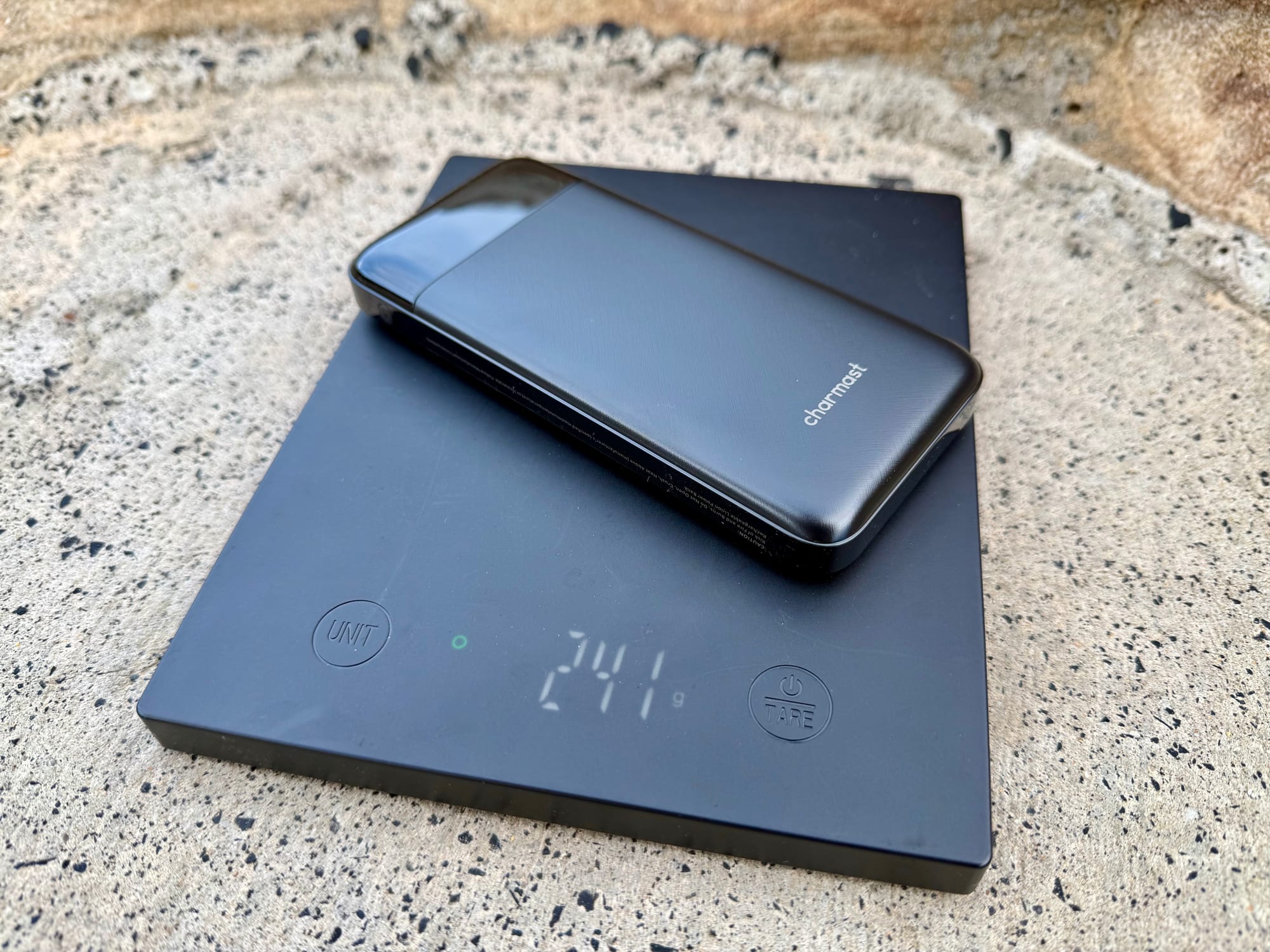 The Charmast 10,000mAh power bank on a scale showing 241 g