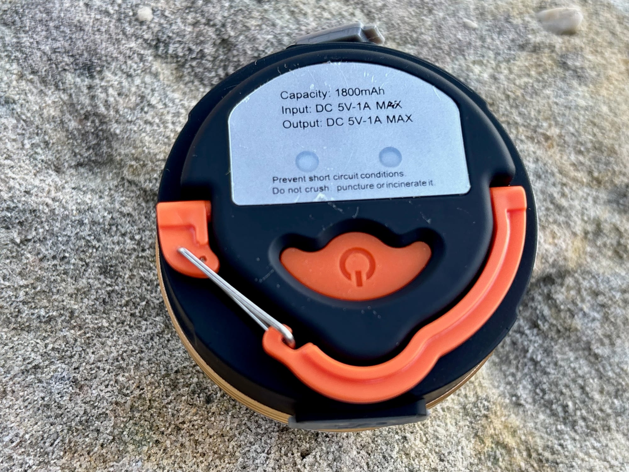 The base of the Clearhill lantern with its orange hook, the power button and the 1800mAh label