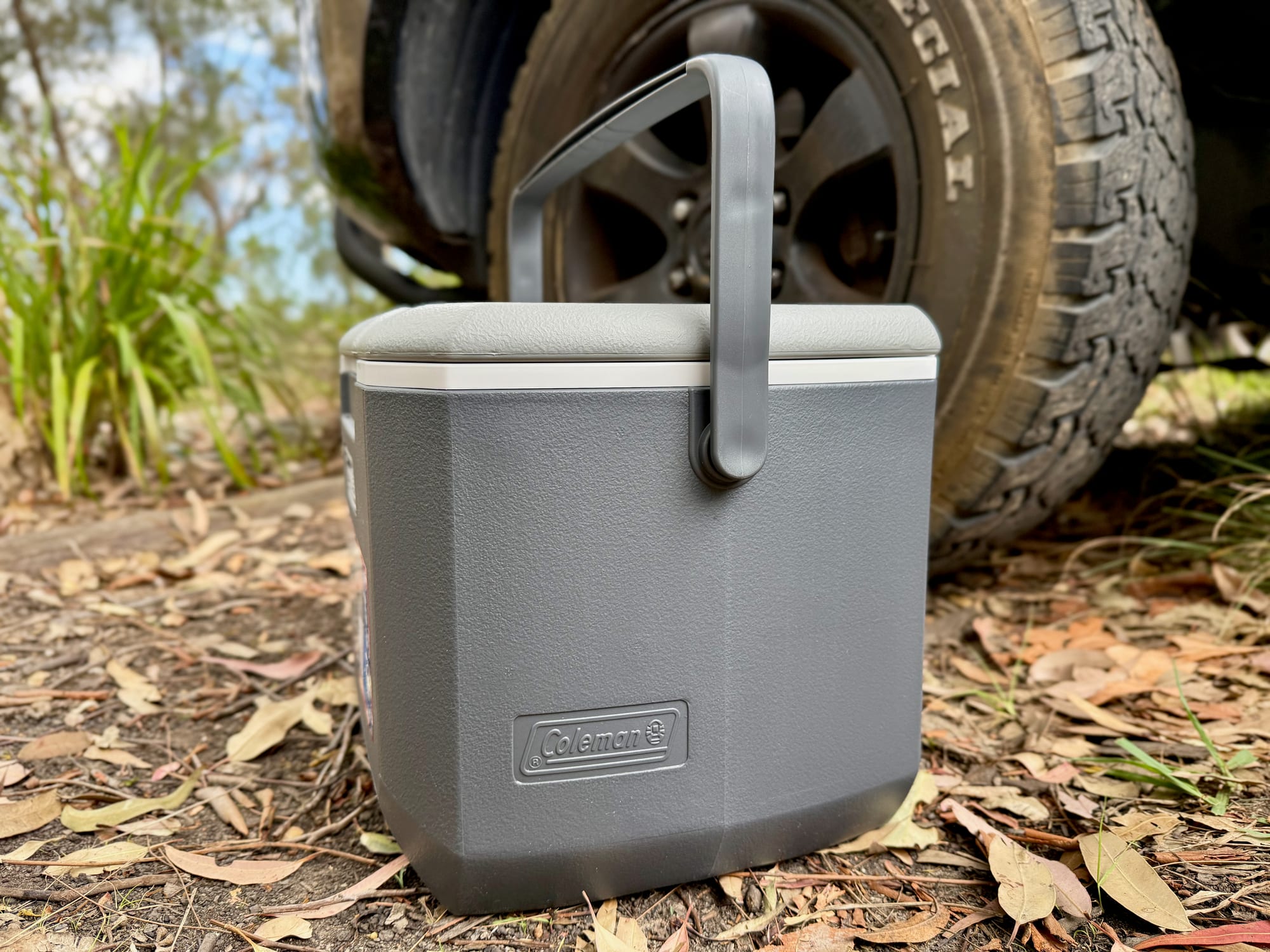 The Coleman 15L hard cooler with its carry handle up