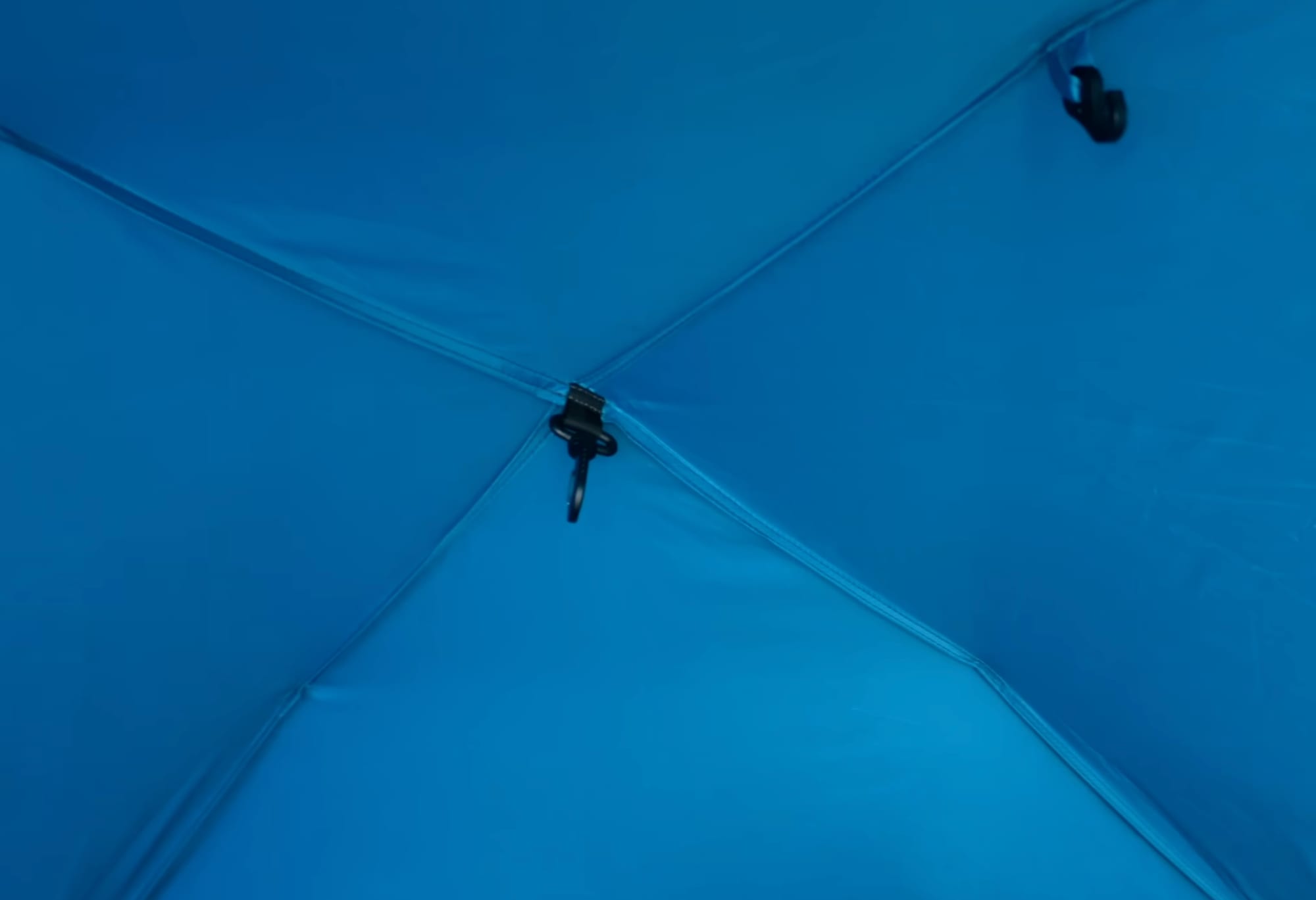 Hooks on the inside of the Coleman tent roof, where the frame meets