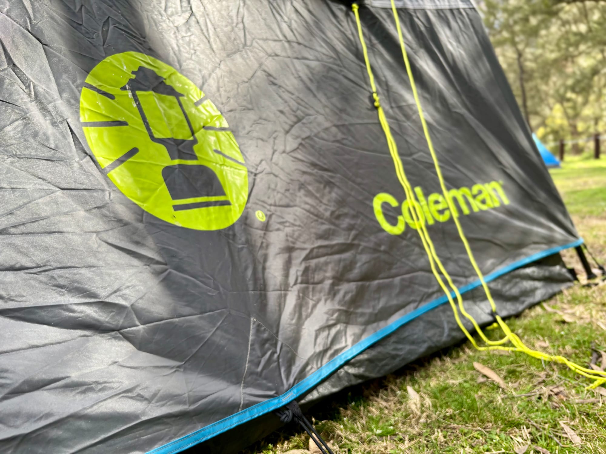 The yellow guy ropes and the Coleman logo on the side of the tent