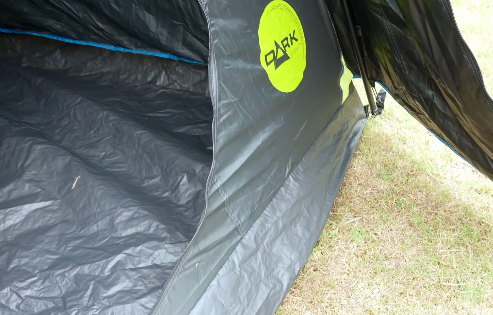 The thin plastic floor inside the Coleman tent, seen through the open door