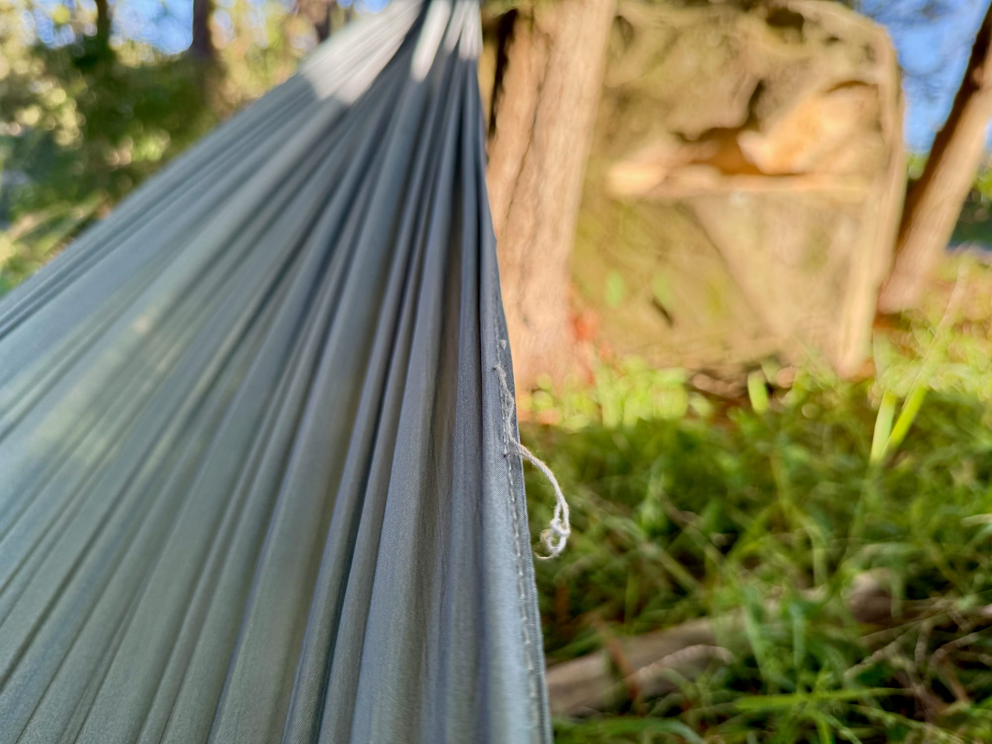 A loose thread hanging from the stitched edge of the Coleman hammock