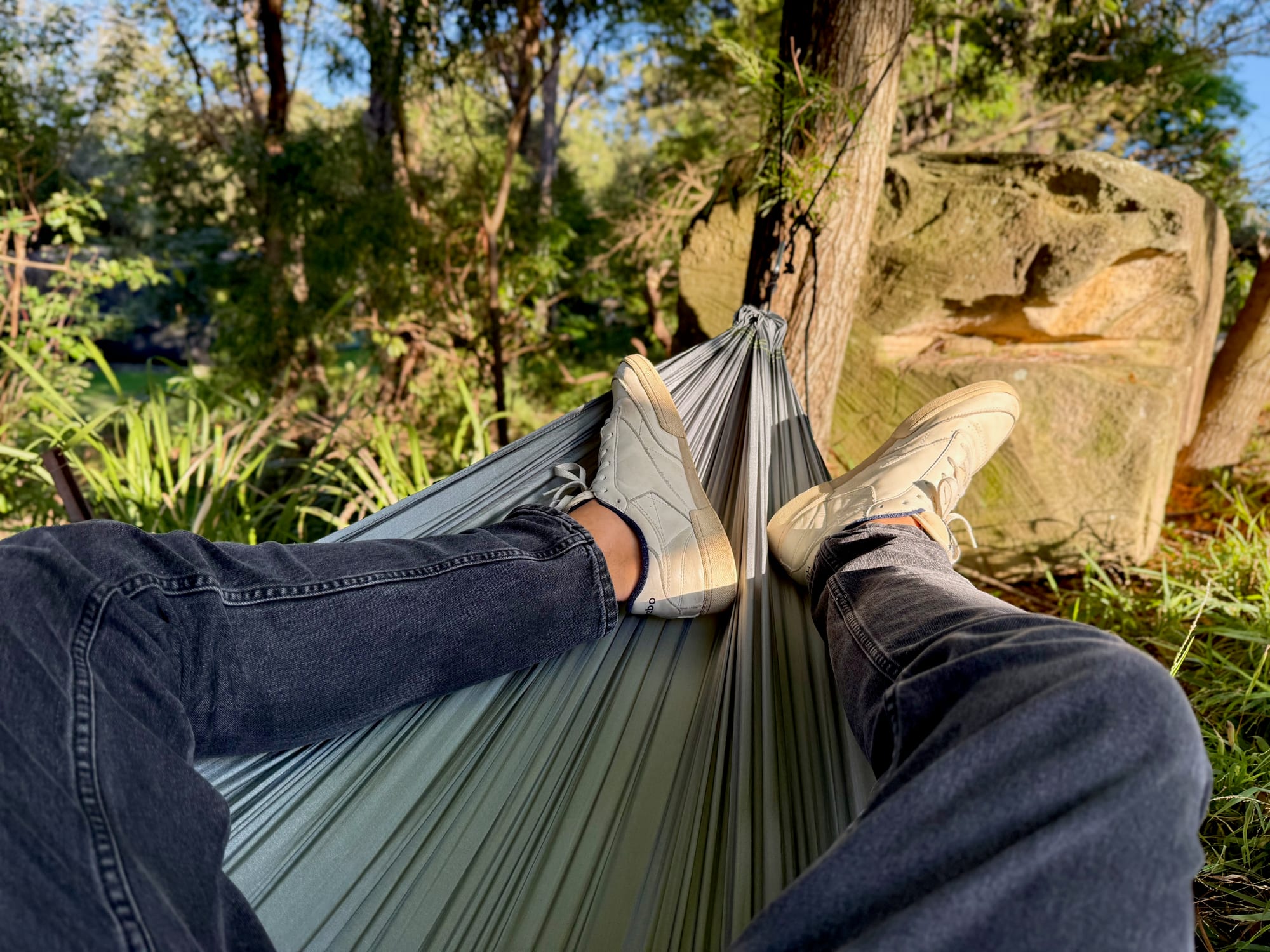 Lying in the Coleman hammock, looking past your legs to the tree