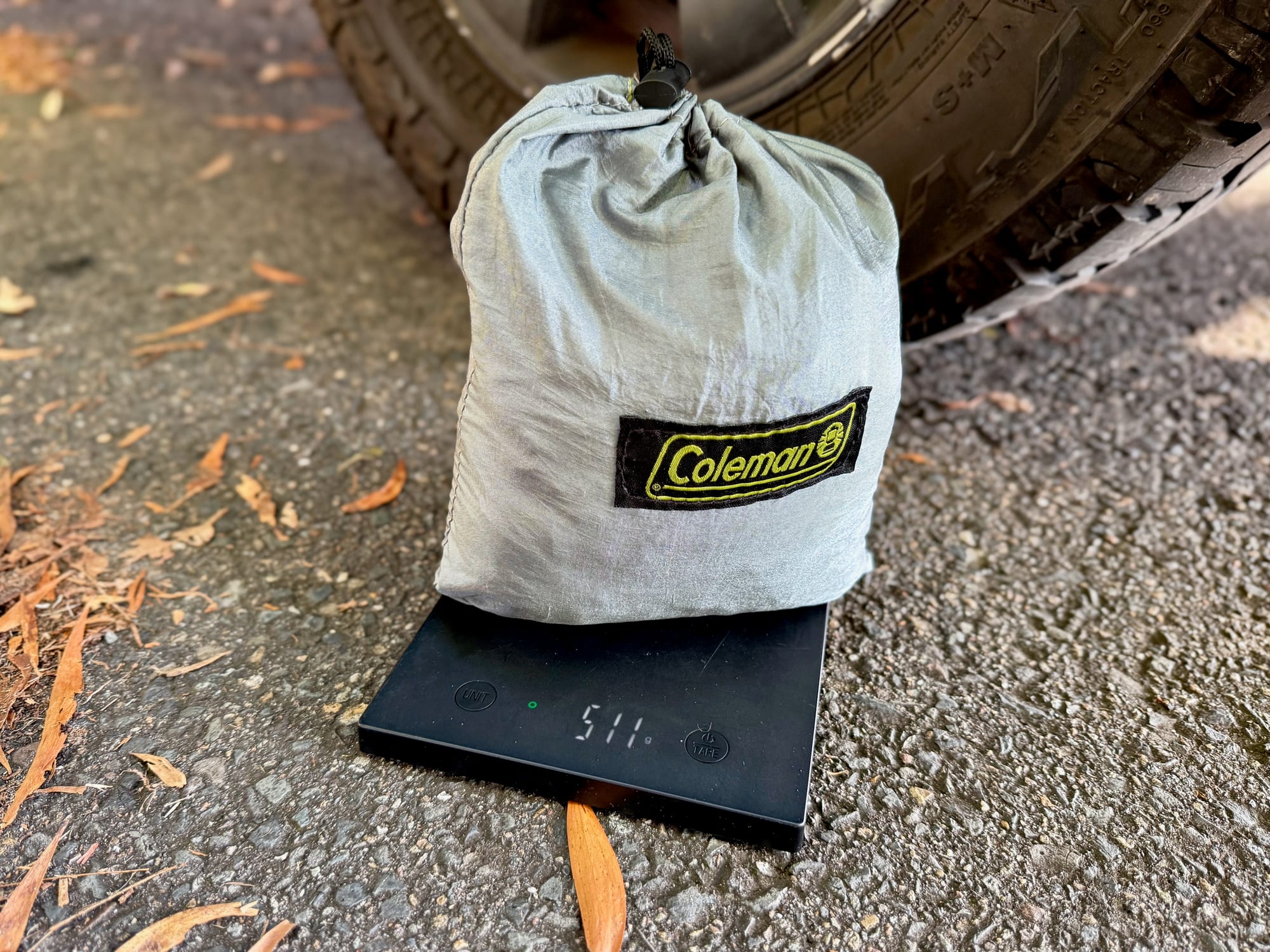 The packed Coleman hammock on a kitchen scale showing 511 g
