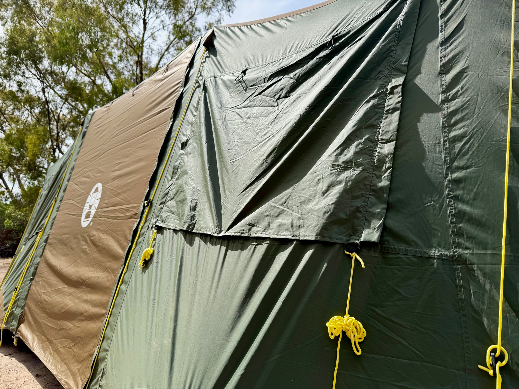 A window flap and the yellow guy ropes on the side of the Coleman Northstar tent