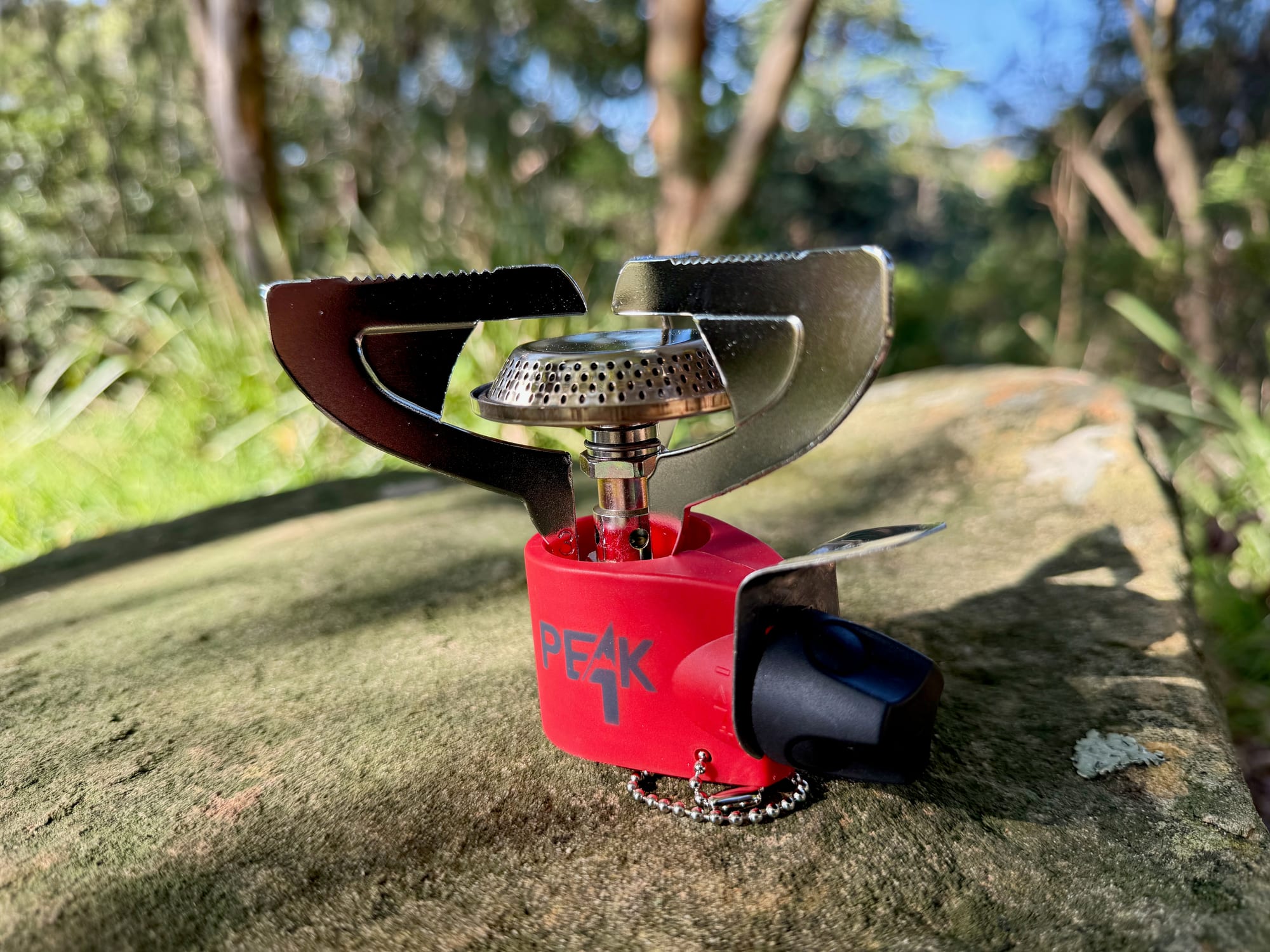The Coleman Peak 1 stove with its three serrated pot supports folded out