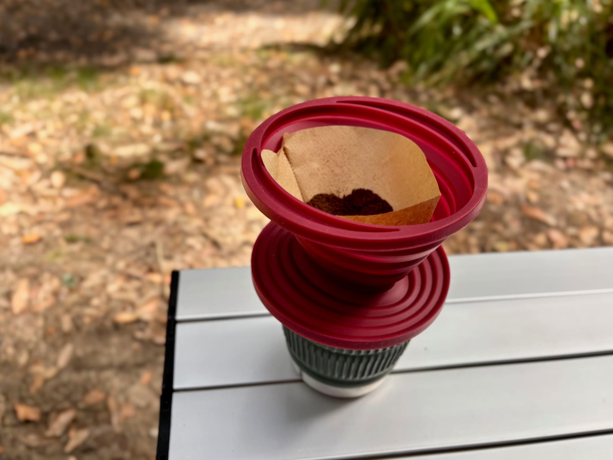 Ground coffee in a paper filter in the collapsible dripper