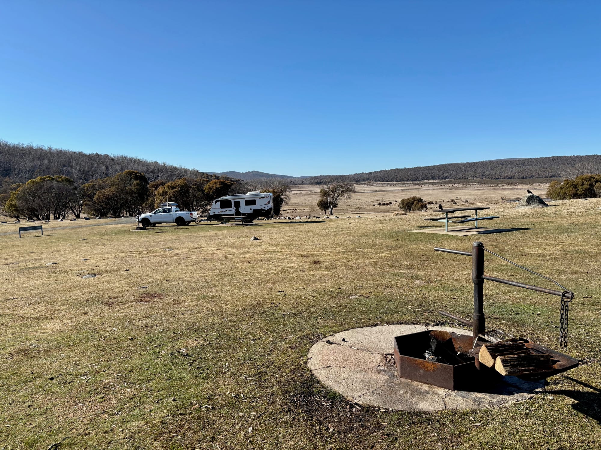 A fire ring on a concrete pad with a swing-out hotplate at Denison Campground