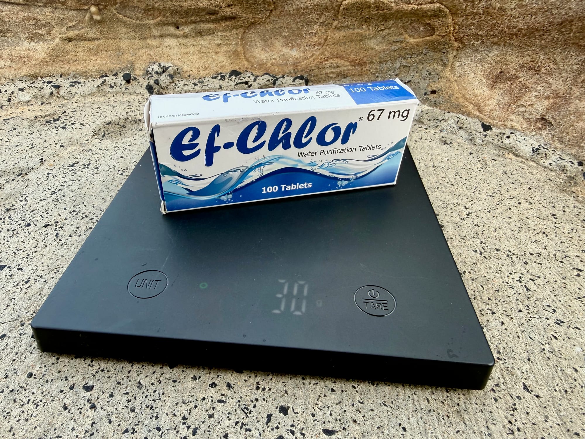 The box of Ef-Chlor tablets on a scale showing 30 g