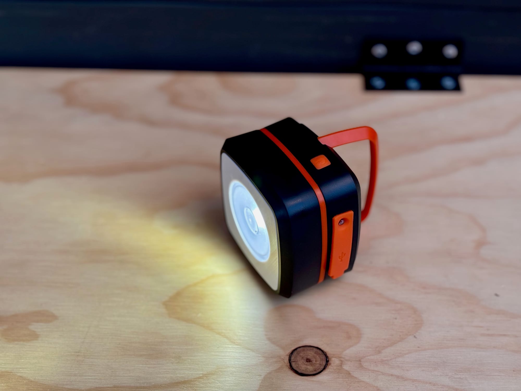 The folded solar lantern on a table, shining like a torch